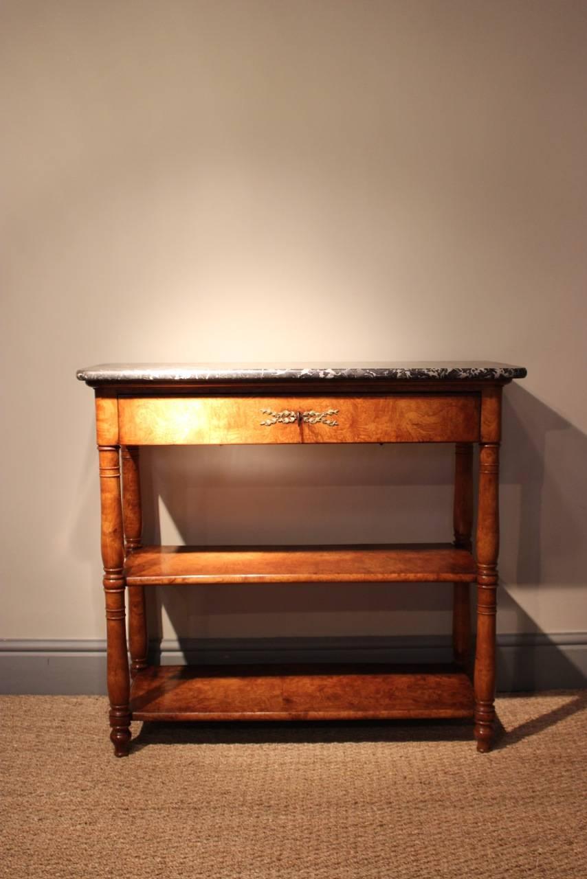 A good quality and of elegant proportions, early 19th century French, Charles X period, console table in burr elm, with its original marble top, and a single drawer, that will work well in most settings.