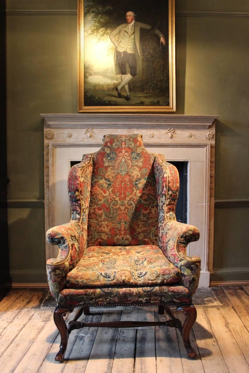 A fine quality and retaining the original upholstery, Queen Anne period, English wing back walnut Country House armchair with a lovely color and shape, that will make a statement in most settings. 

Measures; Height from floor to seat - 41cm.