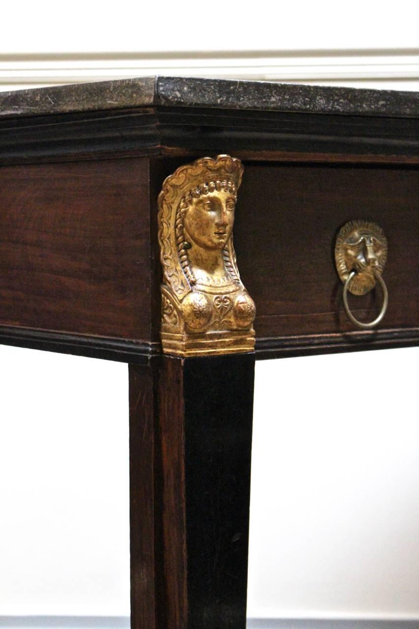 A lovely quality early 19th century French Egyptian revival mahogany console table, with original marble top, brass lion handles and unusual carved and gilded mounts, circa 1810.