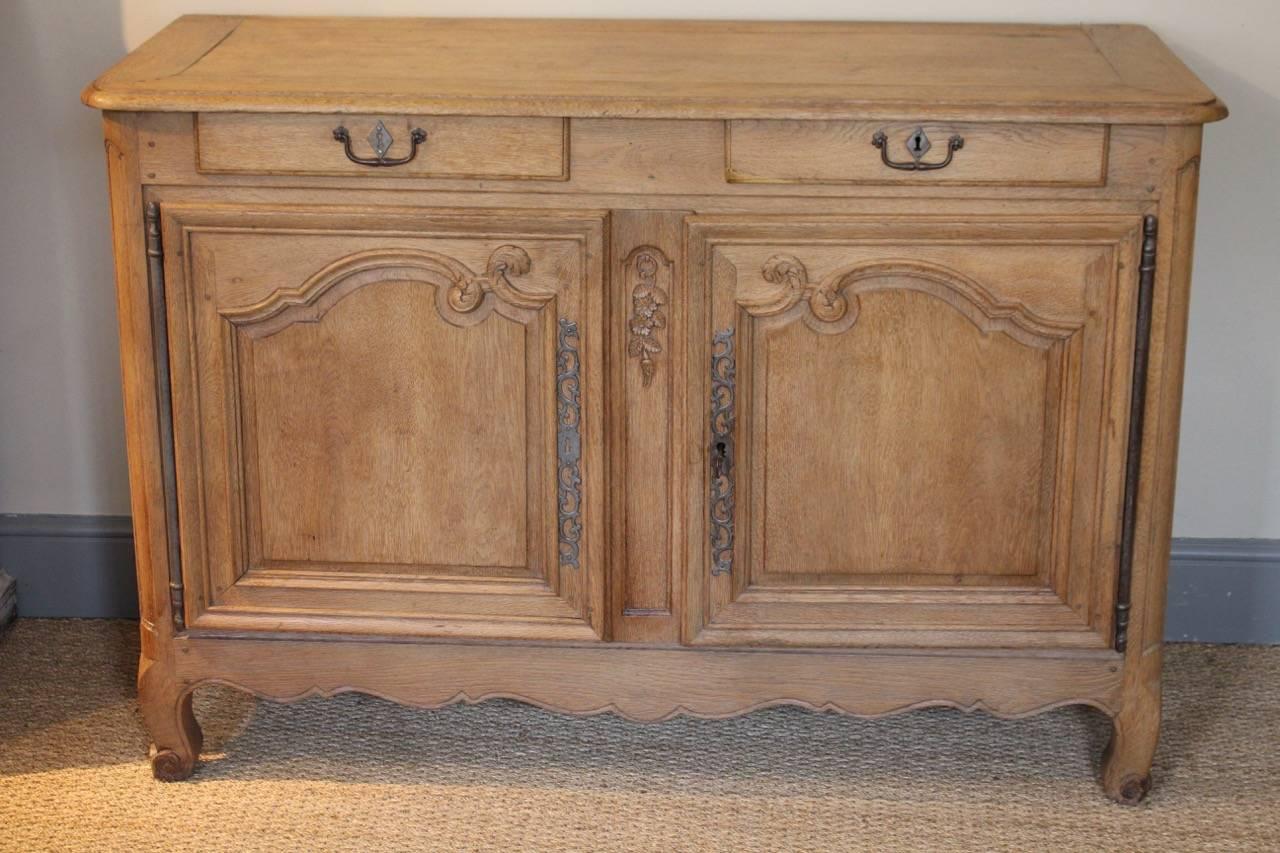 A very charming late 18th century French buffet, in bleached oak, that would make a statement in most settings.