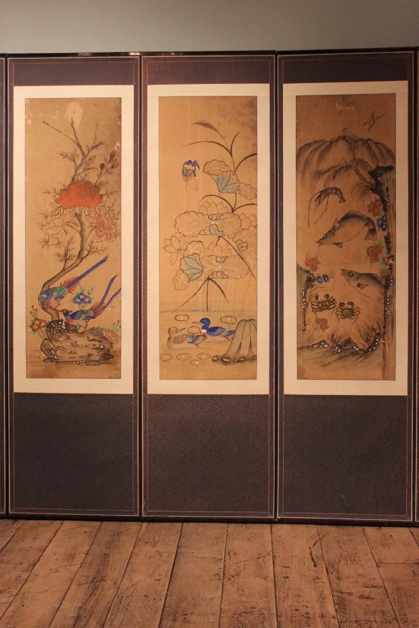 A wonderful, 19th century Korean, eight-fold screen, decorated in colors with birds, flowers and fish, painted on paper that will make a statement in any wall. Great proportions and colors. The birds on the painted panels symbolizing ‘love,’ Korea,