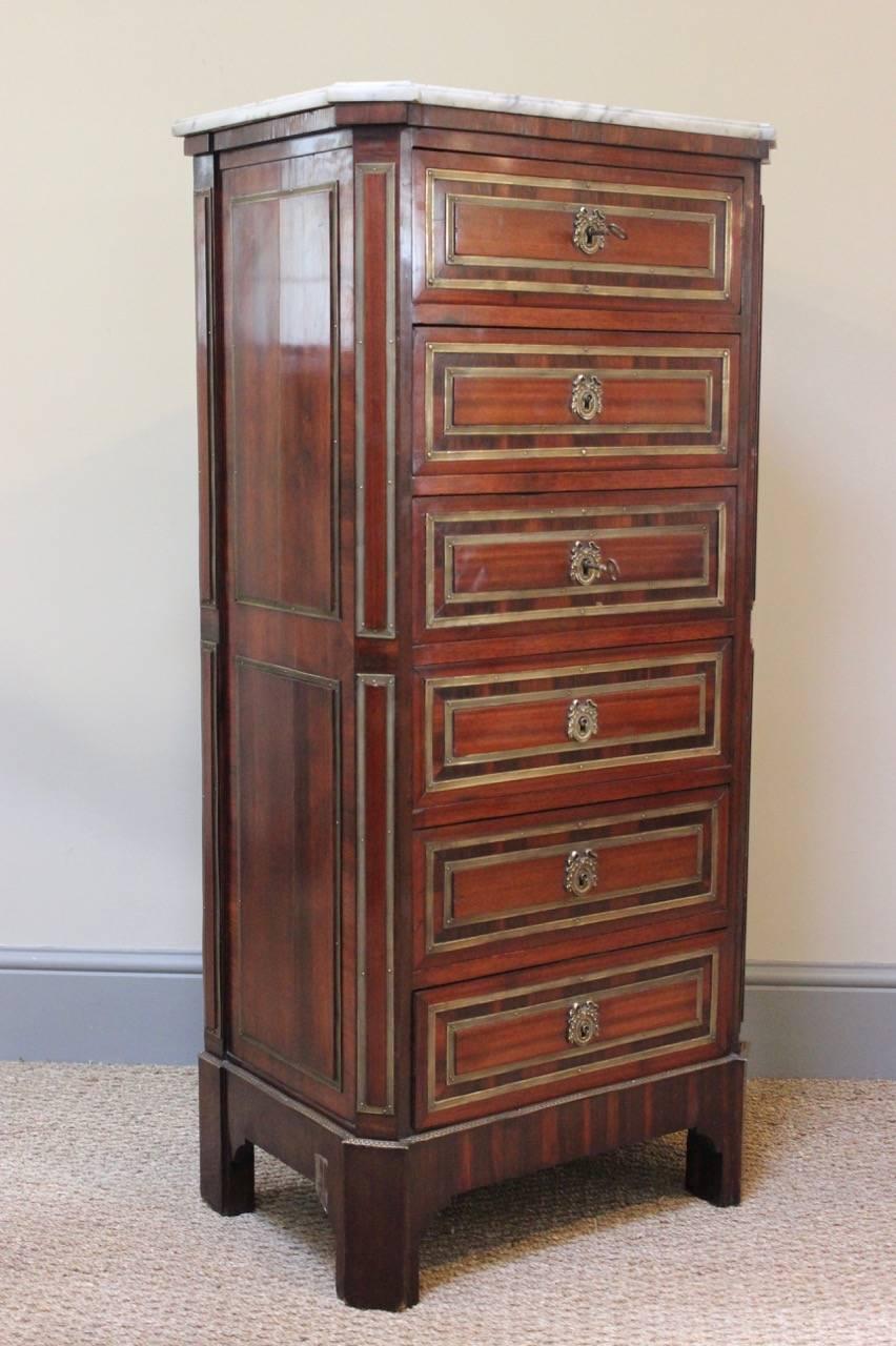 A fine quality and with an excellent color, early 20th century French, Louis XVI style commode, retaining the original marble top and brass mounts. 
This useful commode will work well in a bedroom, offering plenty of storage.
 