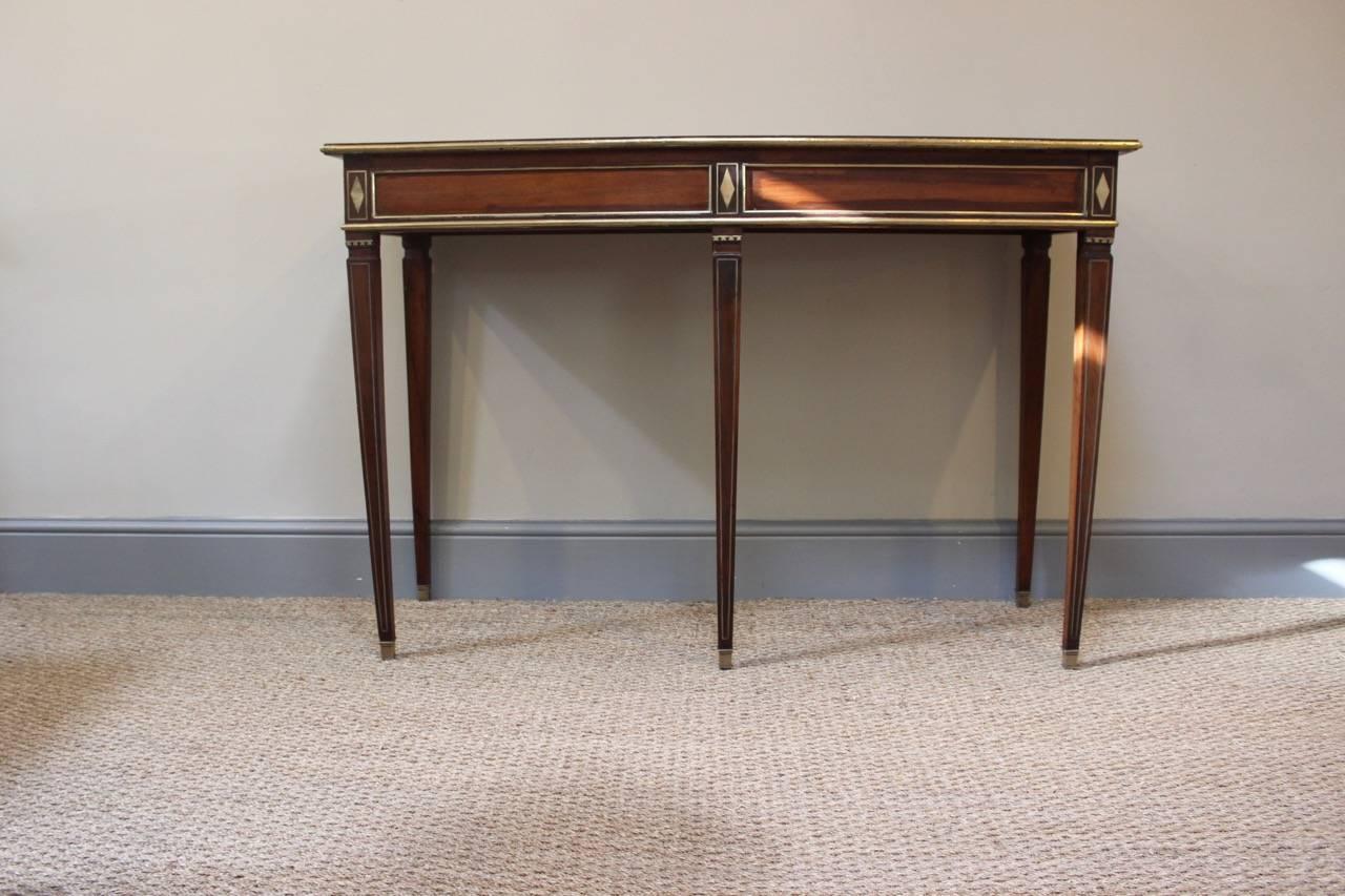 A fine quality and of elegant design, circa 1830 mahogany and brass inlaid Russian console or side table of very clean lines that will work well in either a classic or contemporary setting.
 