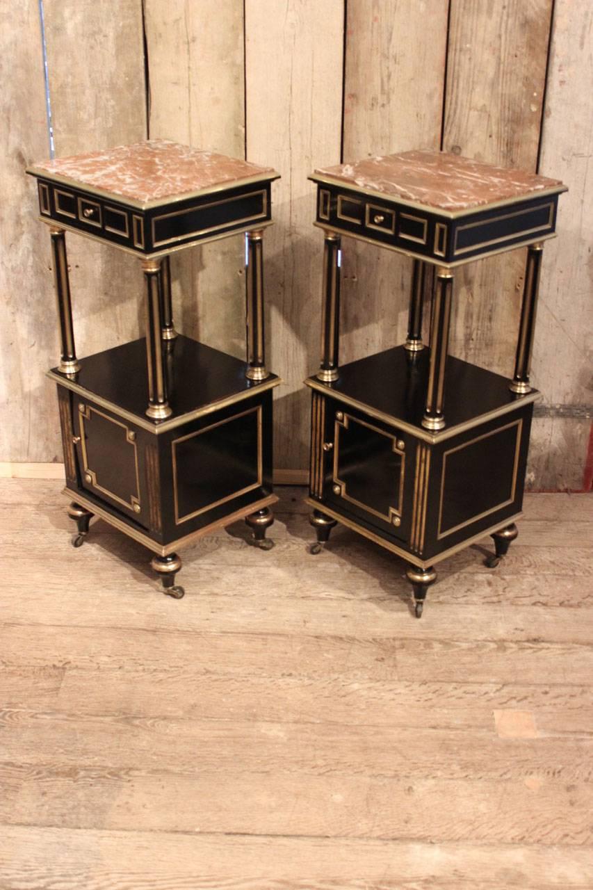 A charming pair of late 19th century, ebonized and bronze-mounted side tables or bedside tables with marble tops, 
France, circa 1880.