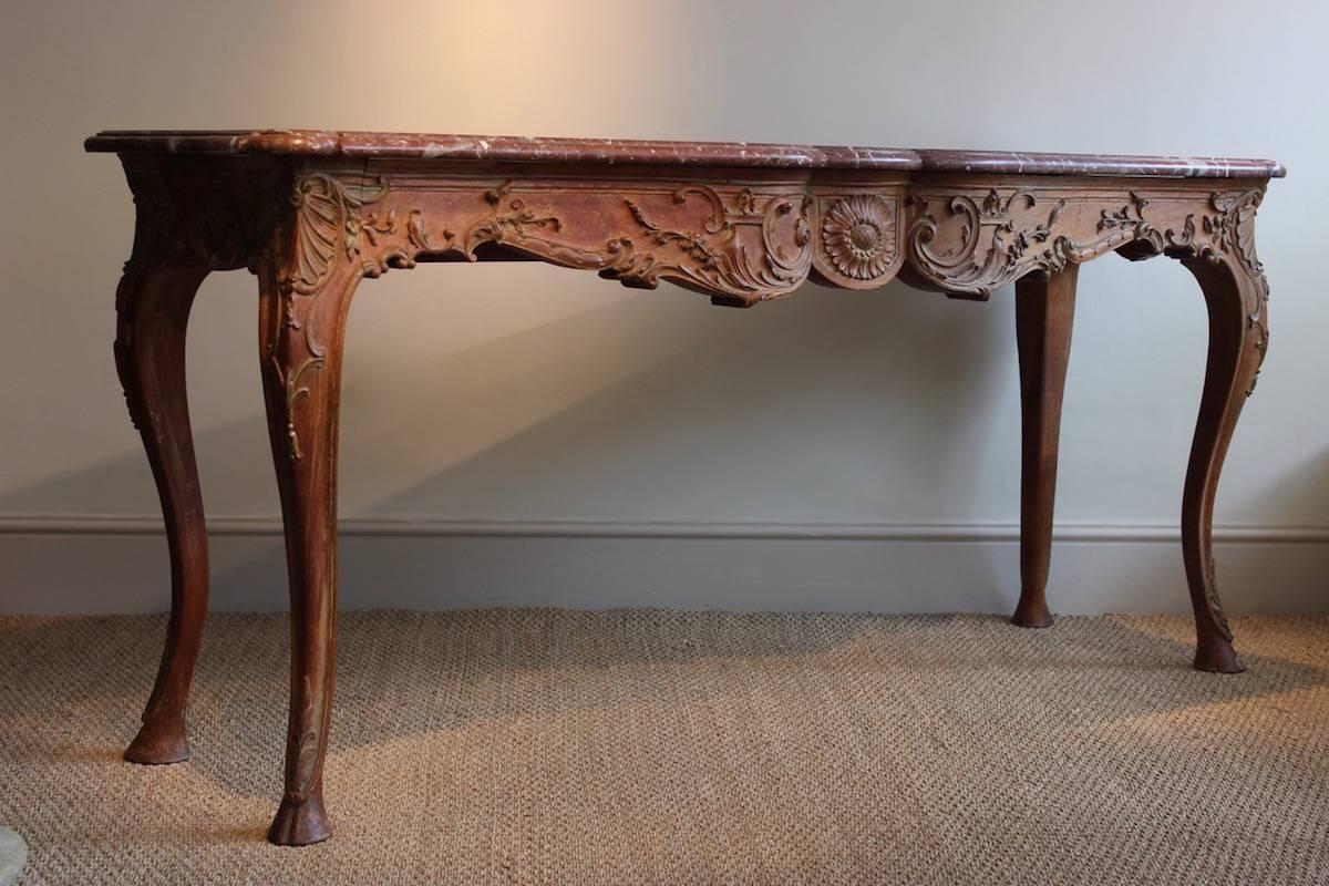 A rare and probably unique carved oak console table by Marc du Plantier. The frieze and legs are each carved from a single piece of oak; as visible in the images the carving is in almost high-relief, evidently by an accomplished hand and unusually