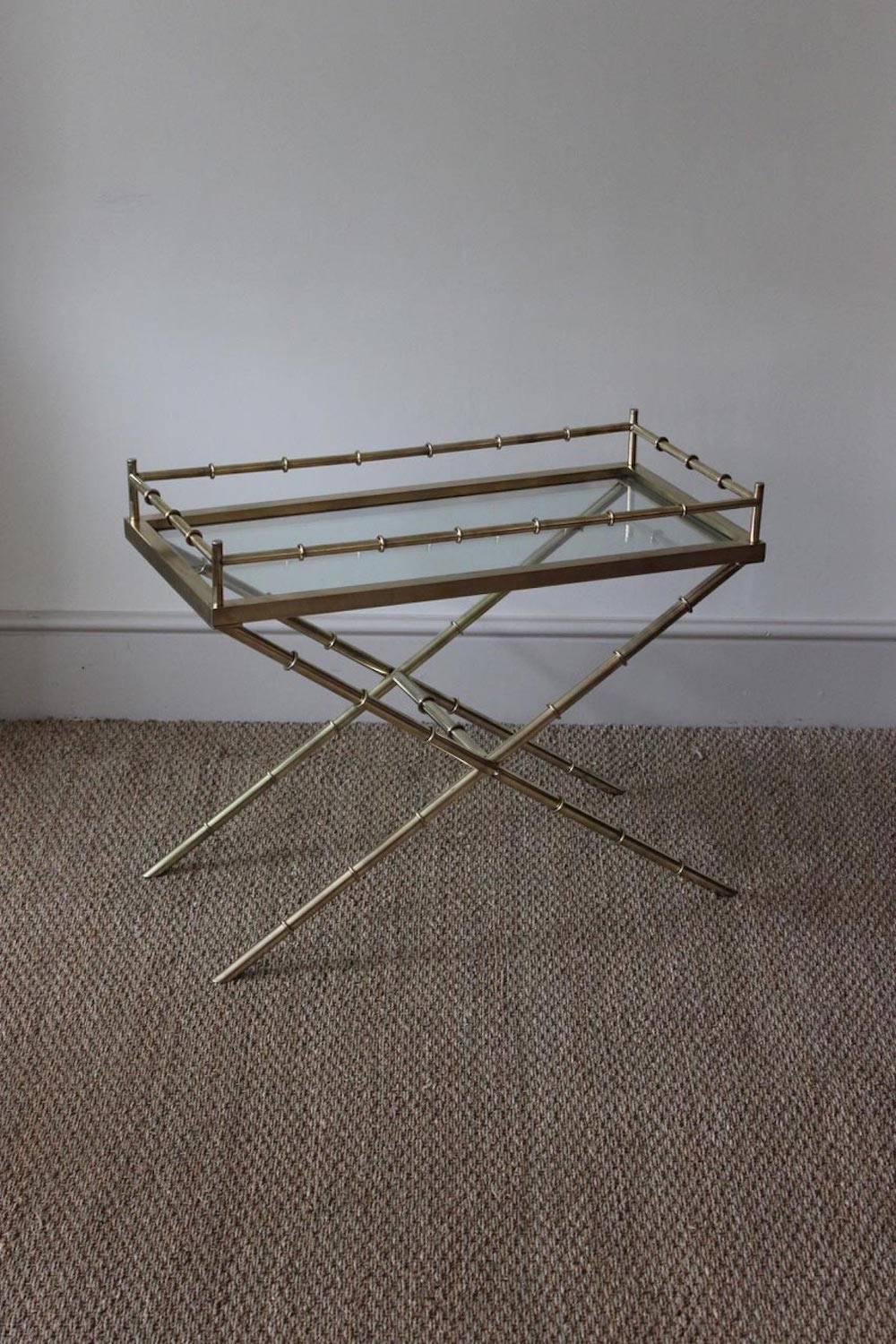 A very good quality and stylish polished brass and glass occasional table with a stylized 'bamboo' frame.