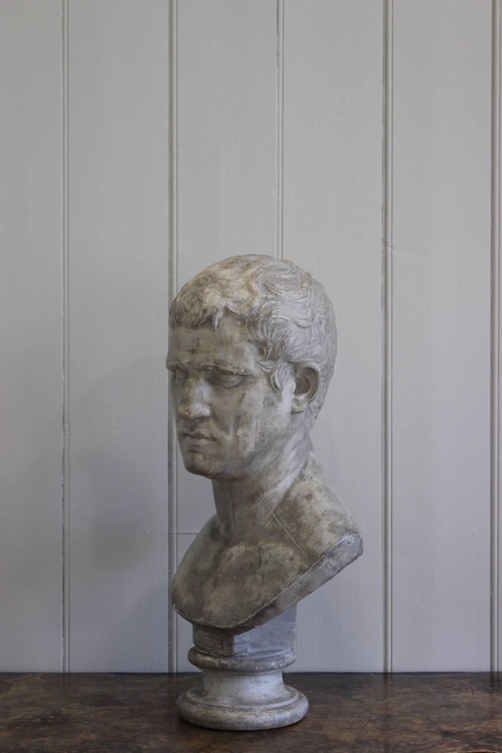 An antique grey-painted plaster bust of the Roman emperor Marcus Agrippa, French or Italian, 19th century.