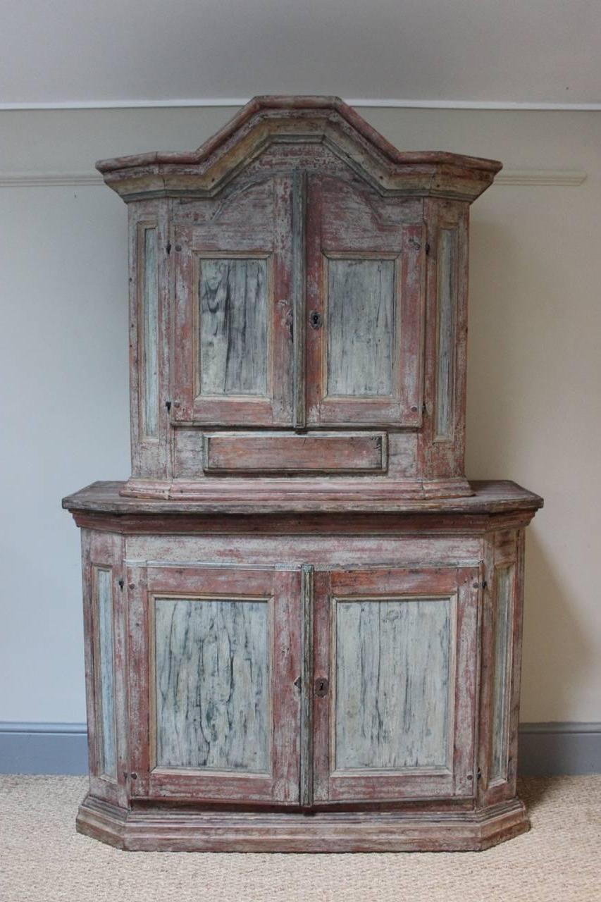 A very charming 18th century painted Swedish baroque cupboard, dry scraped to reveal the original paint, of elegant design, offering plenty of storage , with a single drawer.