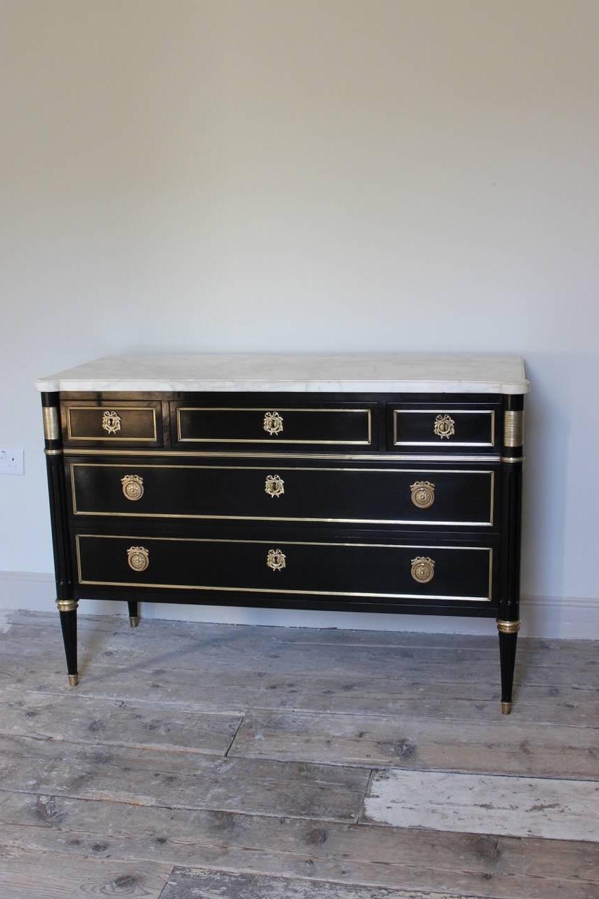 A fine quality and of elegant proportions, circa 1950s French, Louis XVI revival, ebonised commode retaining the original ormolu mounts and marble top. 
