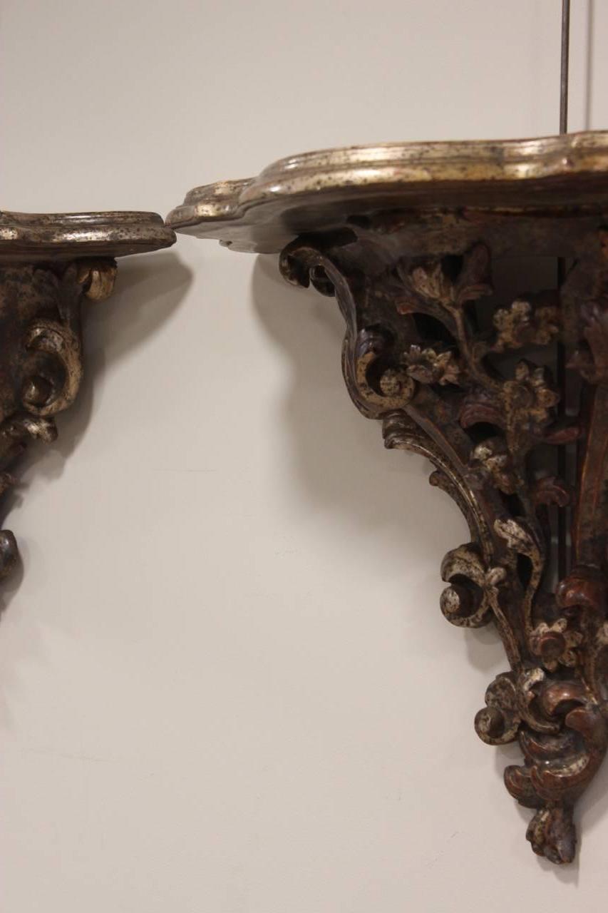 A finely-carved and silvered pair of wall brackets in the rococo style, Italian, circa 1920s	
