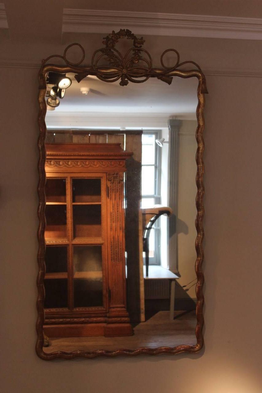 A good and large pair of Napoleon III giltwood ripple-framed mirrors with tasselled and wreathed cresting’s that would work well in most settings, French, late 19th century.
 