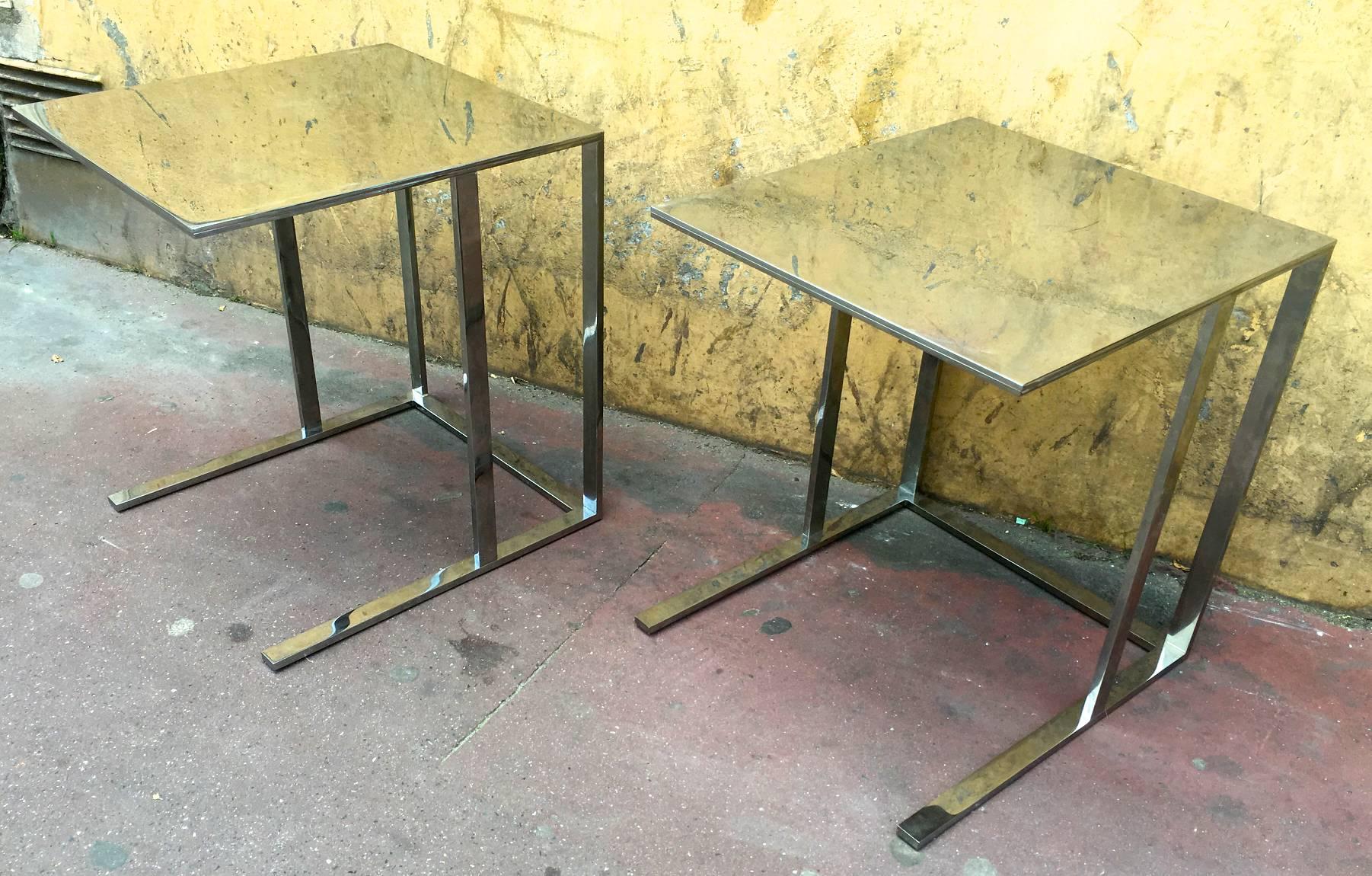 Pair of modern polished steel side tables with pure design.