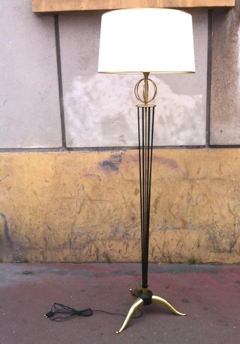 Maison Arlus documented pair of standing lamps with globe and tripod legs.