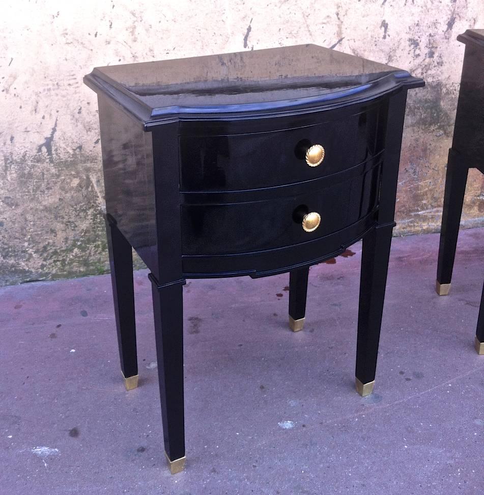 Maison Jansen refined pair of black lacquered bedsides or side tables with gold bronze knob and leg sabot.