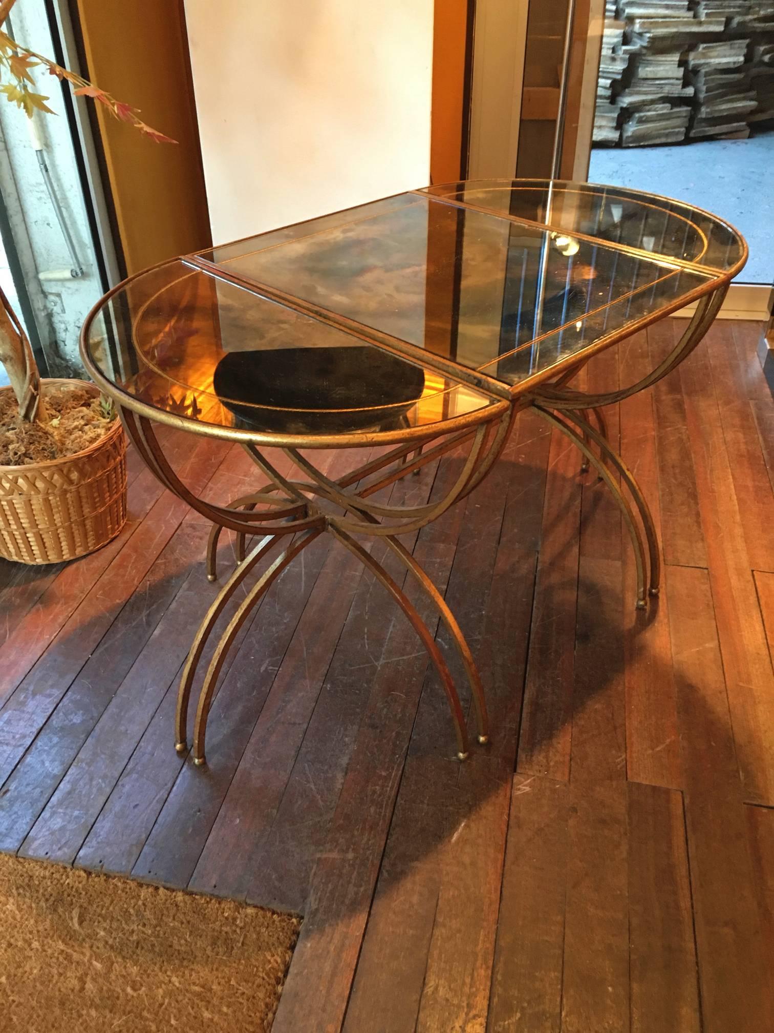 Maison Baguès semi-sphere gold leaf iron three part coffee table with églomisé top can be modulated in side table and rectangular or round tables.
 