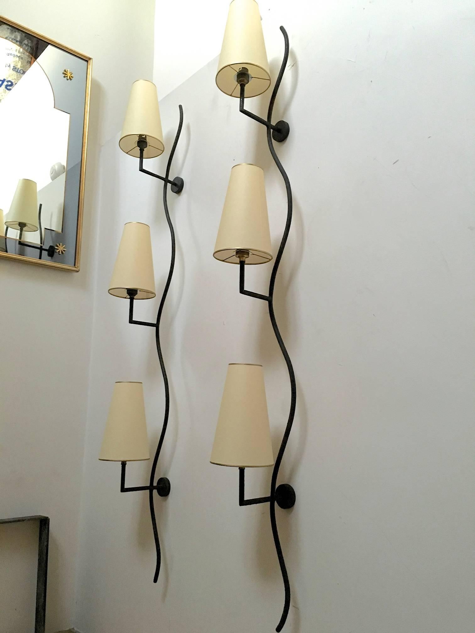 Jean Royère pair of vertical "ondulation" three lights sconces in vintage condition.
    