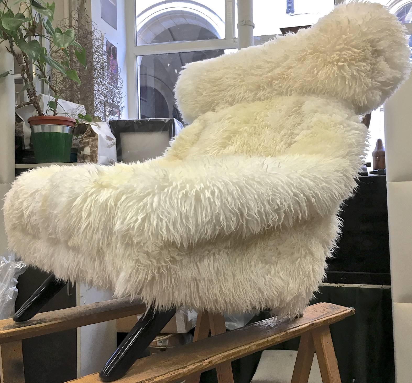 Illum Wikkelso spectacular hammer lounge chair covered in natural sheepskin fur with great comfort.