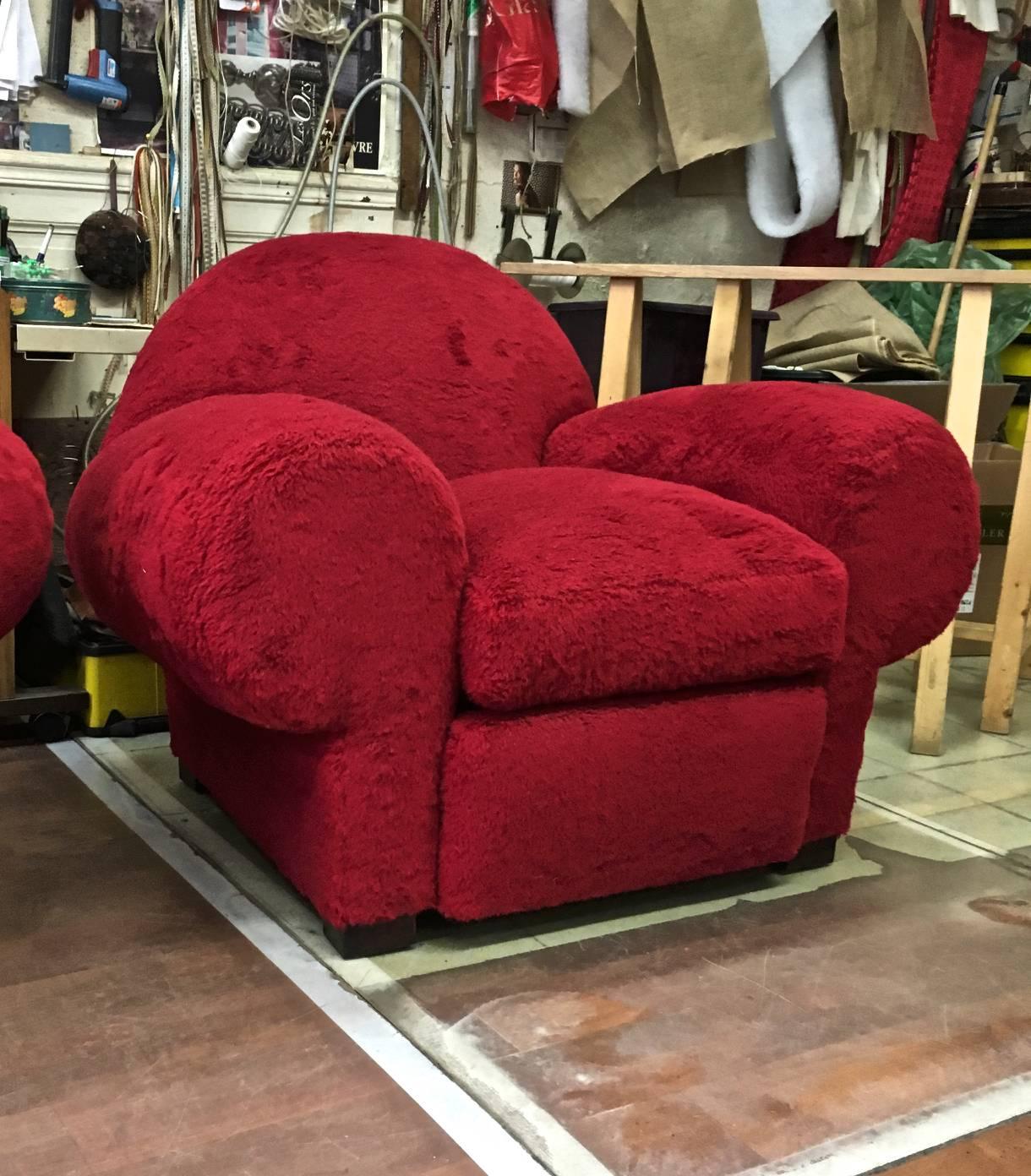 Jean Royère for Gouffé stamped pair of big bulky red club chairs covered in red wool faux fur.