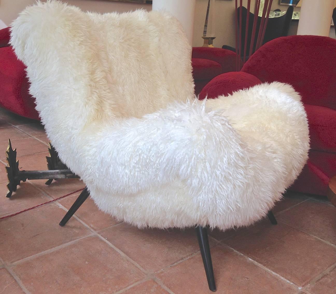 Fritz Neth rarest spectacular wood legged lounge chairs covered in sheepskin fur.
