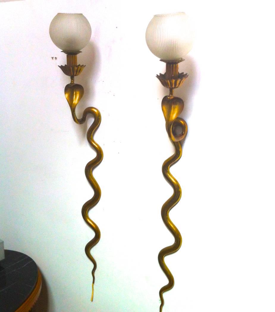 Spectacular cobra shaped gold bronze pair of long sconces with opaline globe.