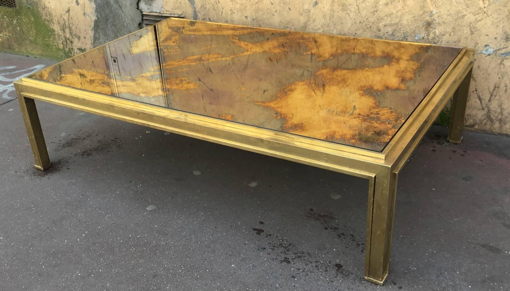 Jacques Adnet sturdy gold bronze big coffee table with a gold leaf mirrored top.