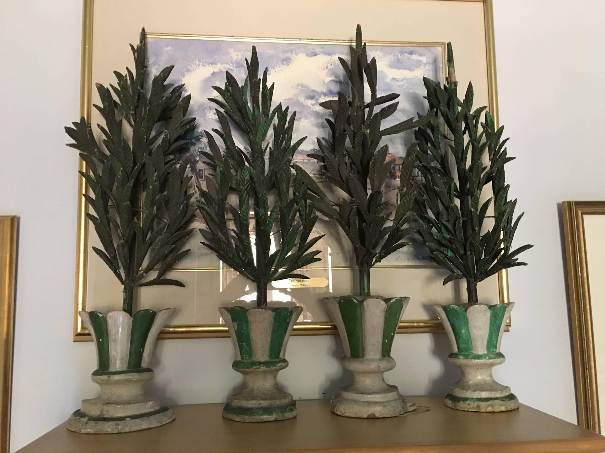 Four charming 19th century Italian wood-carvings of trees in pots. Painted cream and green. Charming, subtle and tasteful, to hang on the wall in a garden room or to Stand alone. The items are three-dimensional with a depth of 9