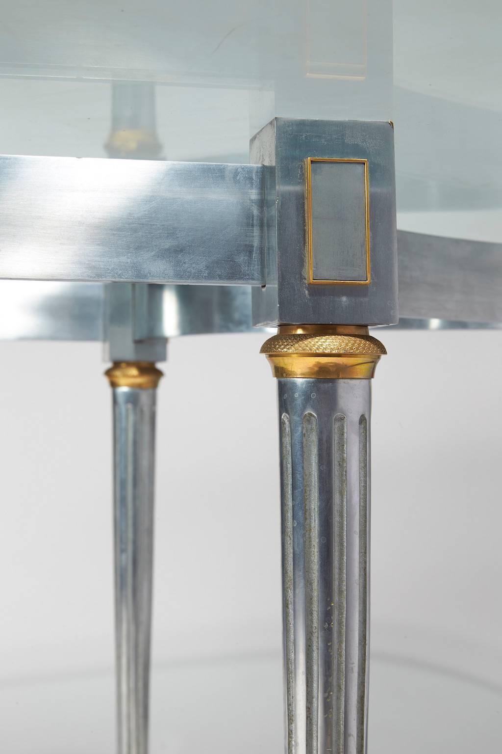 Cylindrical and fluted steel legs with gilded bronze end-legs
Glass top
neoclassic style.