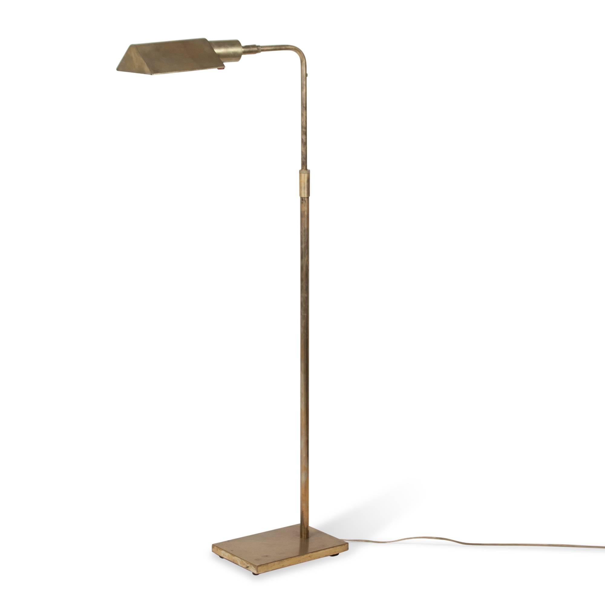 Brass reading or table lamp, the arm rotatable, of adjustable height, with rectangular base, by Koch and Lowy, United States, 1960s. Stamped signature. Overall height 41 in. Length of arm at top 15 in. Base measures 9 1/4 in x 6 1/4 in.
