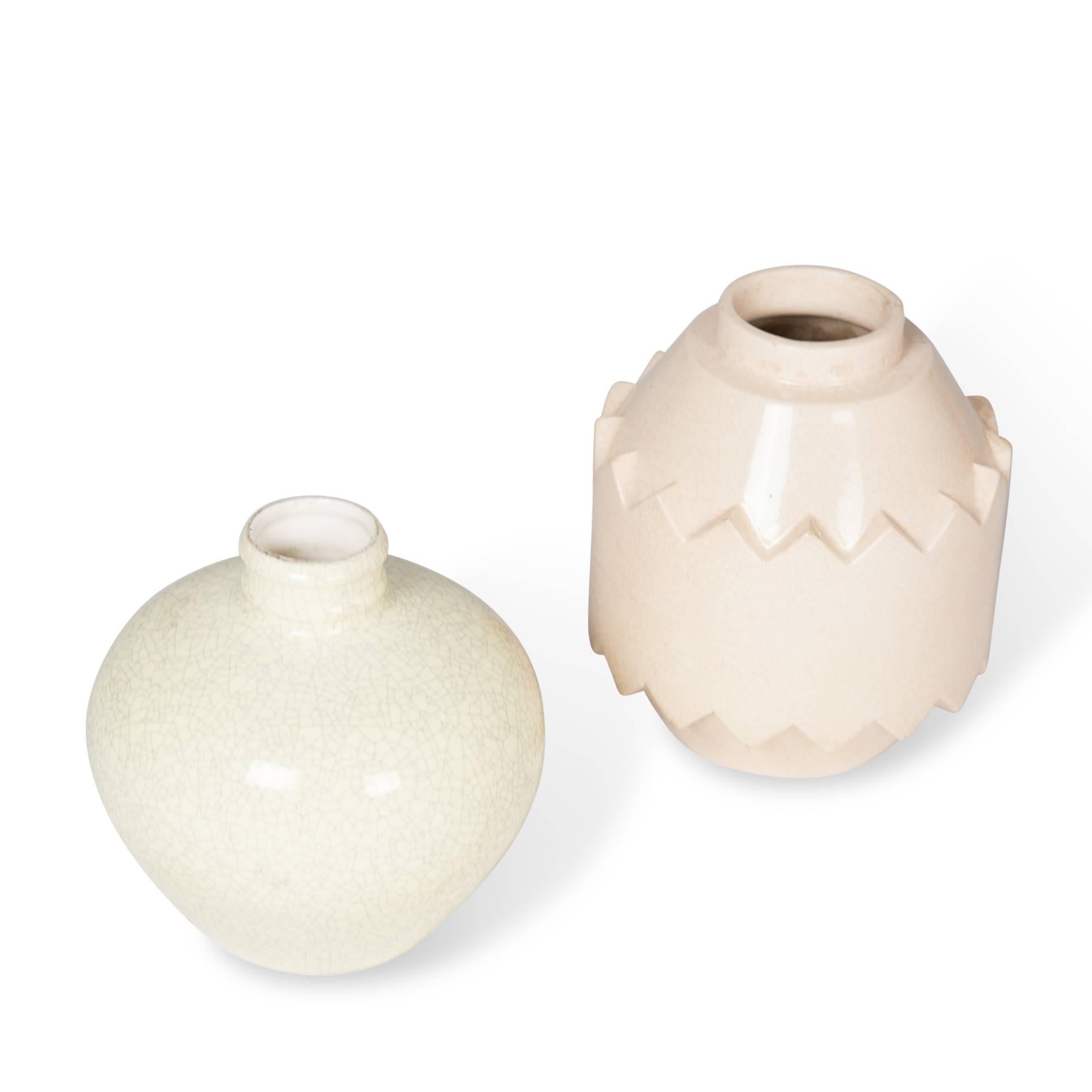 Two ceramics.
On left: Off-white crackle glazed ceramic vase, bulbous form with short neck, by Boch La Louviere, Belgium 1930s. Signed to underside. Height 7 in, diameter 7 in.

On right: Beige crackle glaze ceramic vase, of cylindrical form and
