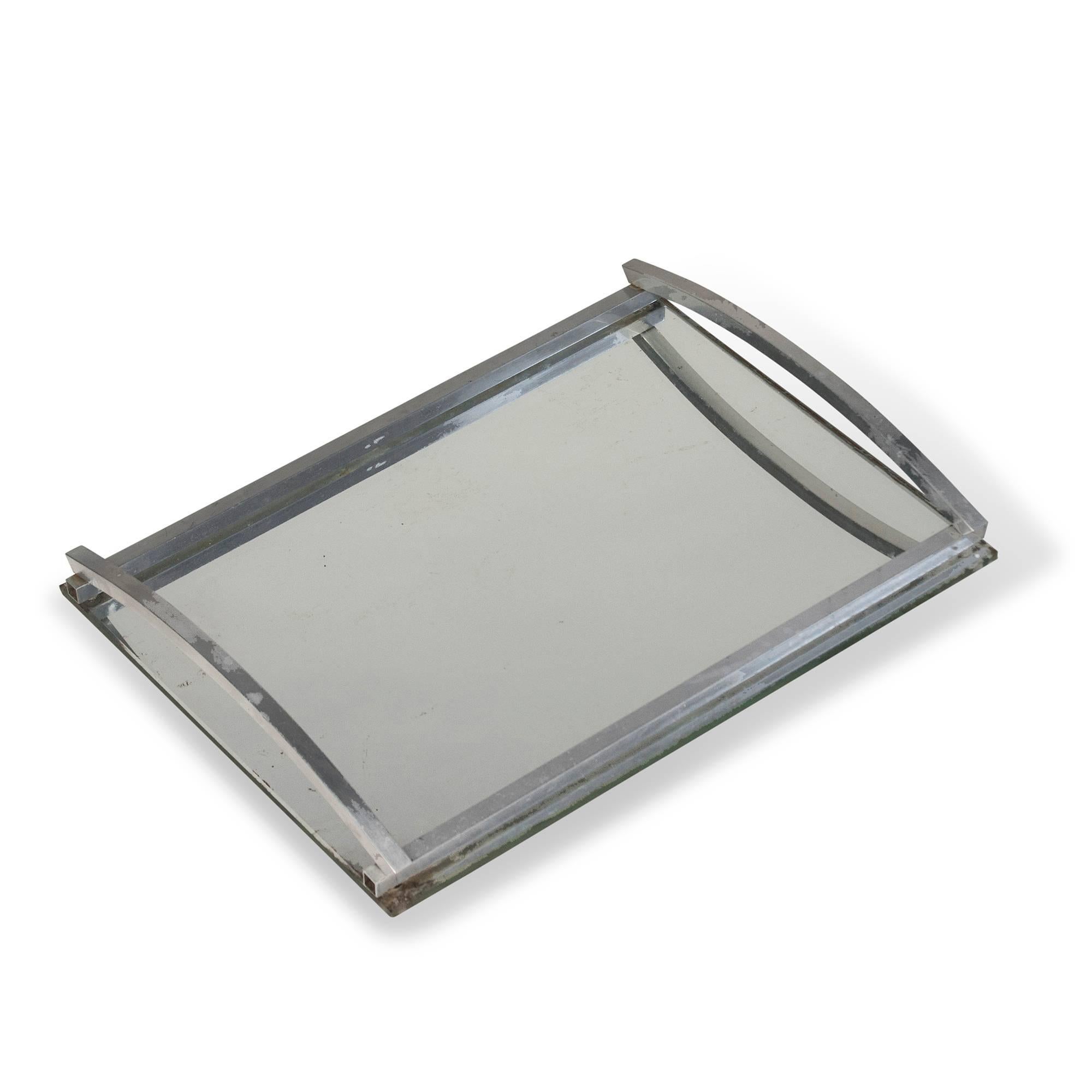 Nickeled frame mirror surface serving tray, with arced raised end handles, French, 1930s. Measures: 14 in x 10.6 in. 