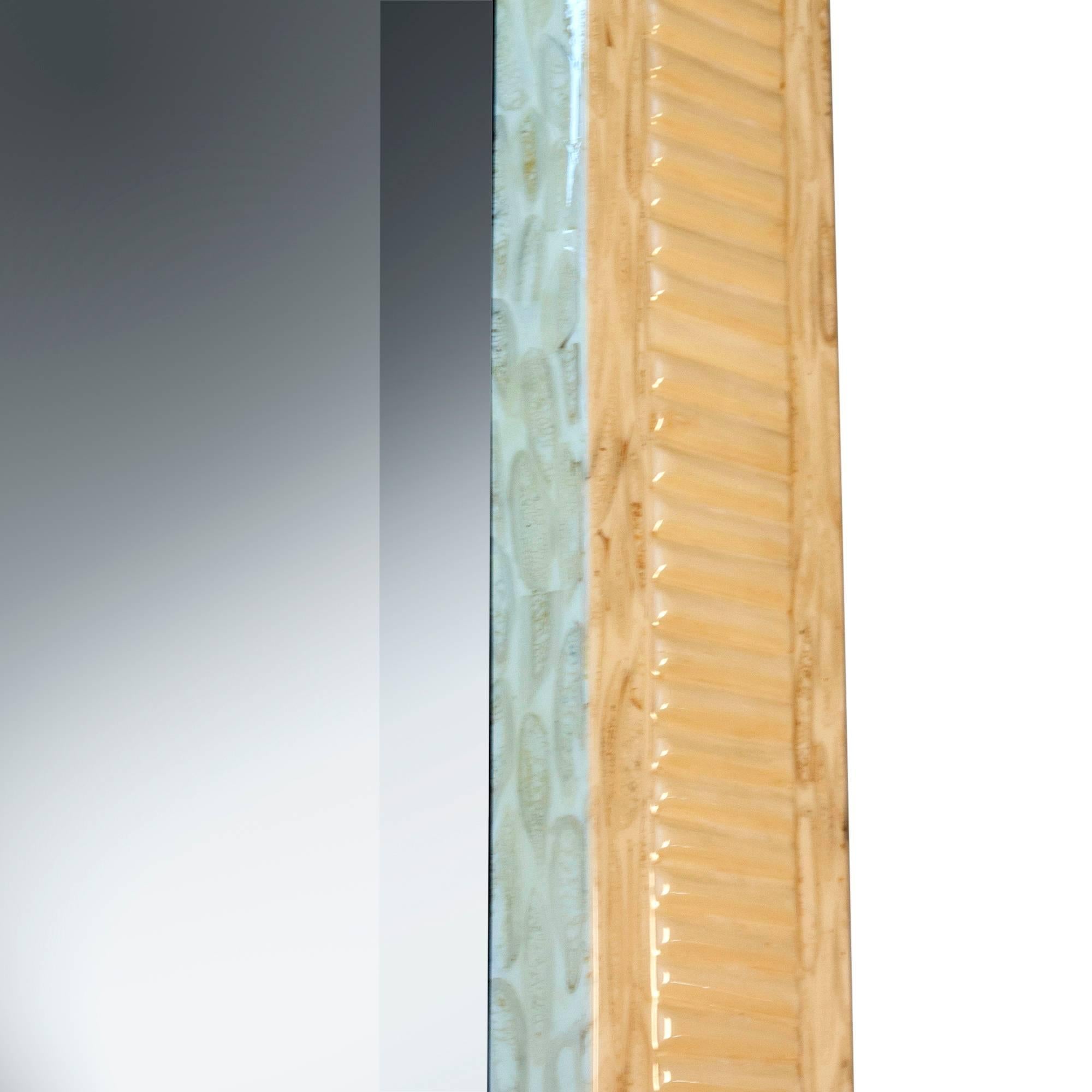 Rectangular arch top bone-color lacquered mirror, the frame with ripple texturing, by Enrique Garcez, Columbian for the American market, in the style of Karl Springer, marked to backside. Measures: 66 1/2 in x 30 1/4 in, depth 1 1/2 in. (sats)