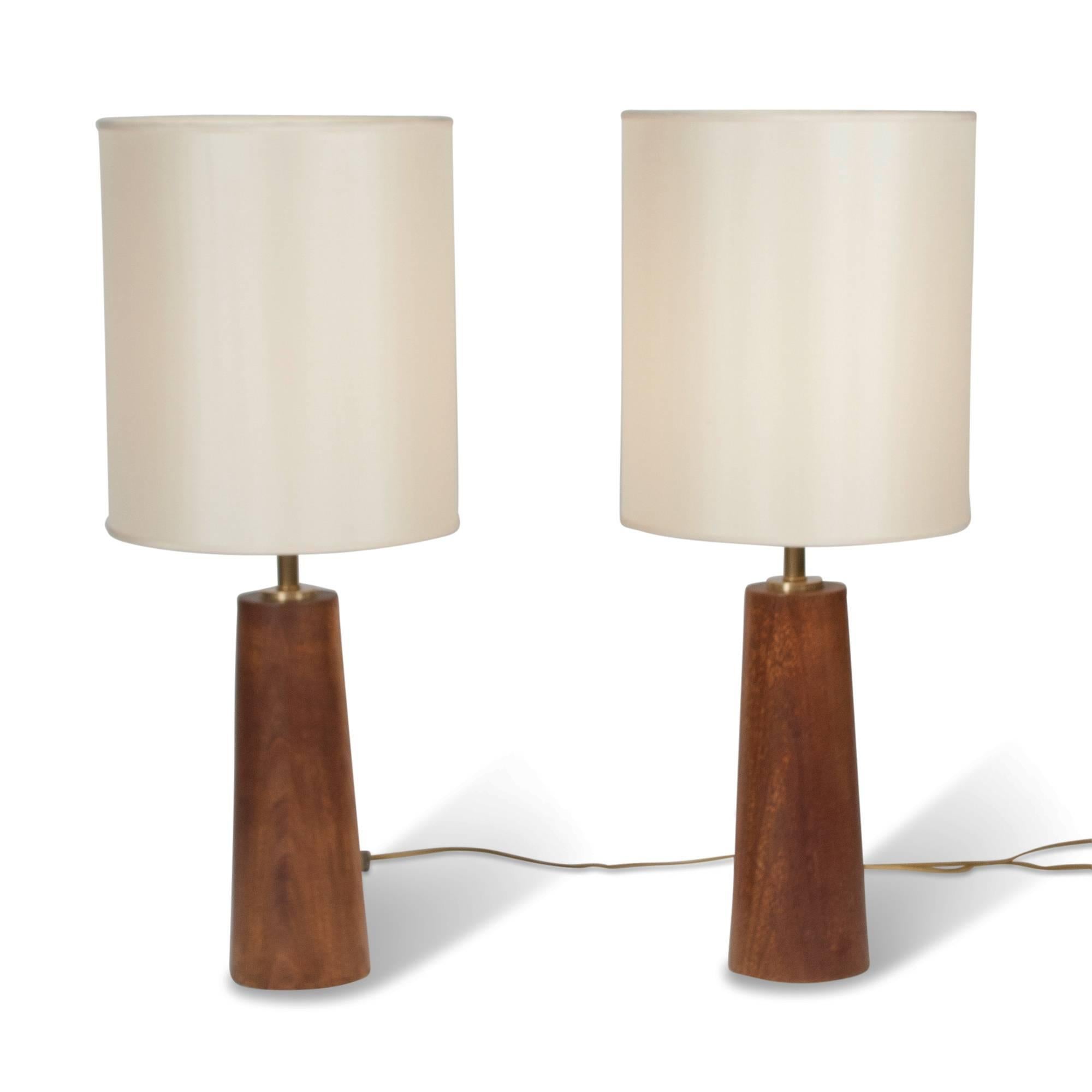 Pair of turned mahogany column table lamps, in custom shades, Denmark, 1950s. Measures: Overall height 30 in, diameter of base 5 in. Shade measure top diameter 12 in, bottom diameter 12 in, height 14 in.
 
