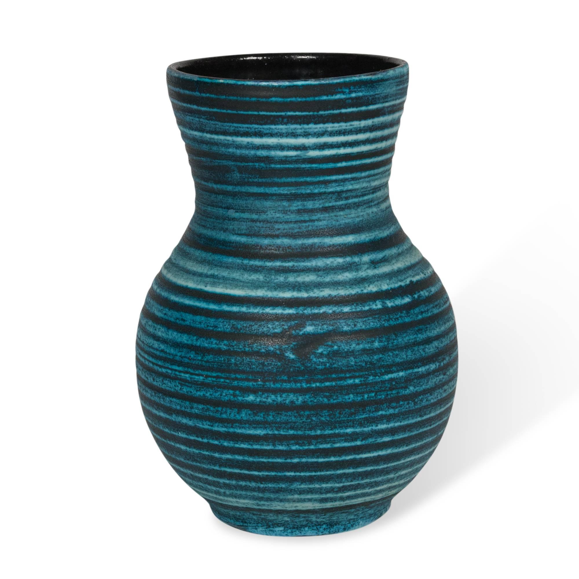 Blue banded ceramic vase, ovoid shape with flared rim, the pale blue bands over a darker blue base with a black inteior. By Accolay, France, 1960s. Signed to underside. Measures: Height 12 in, diameter of opening 6 in.