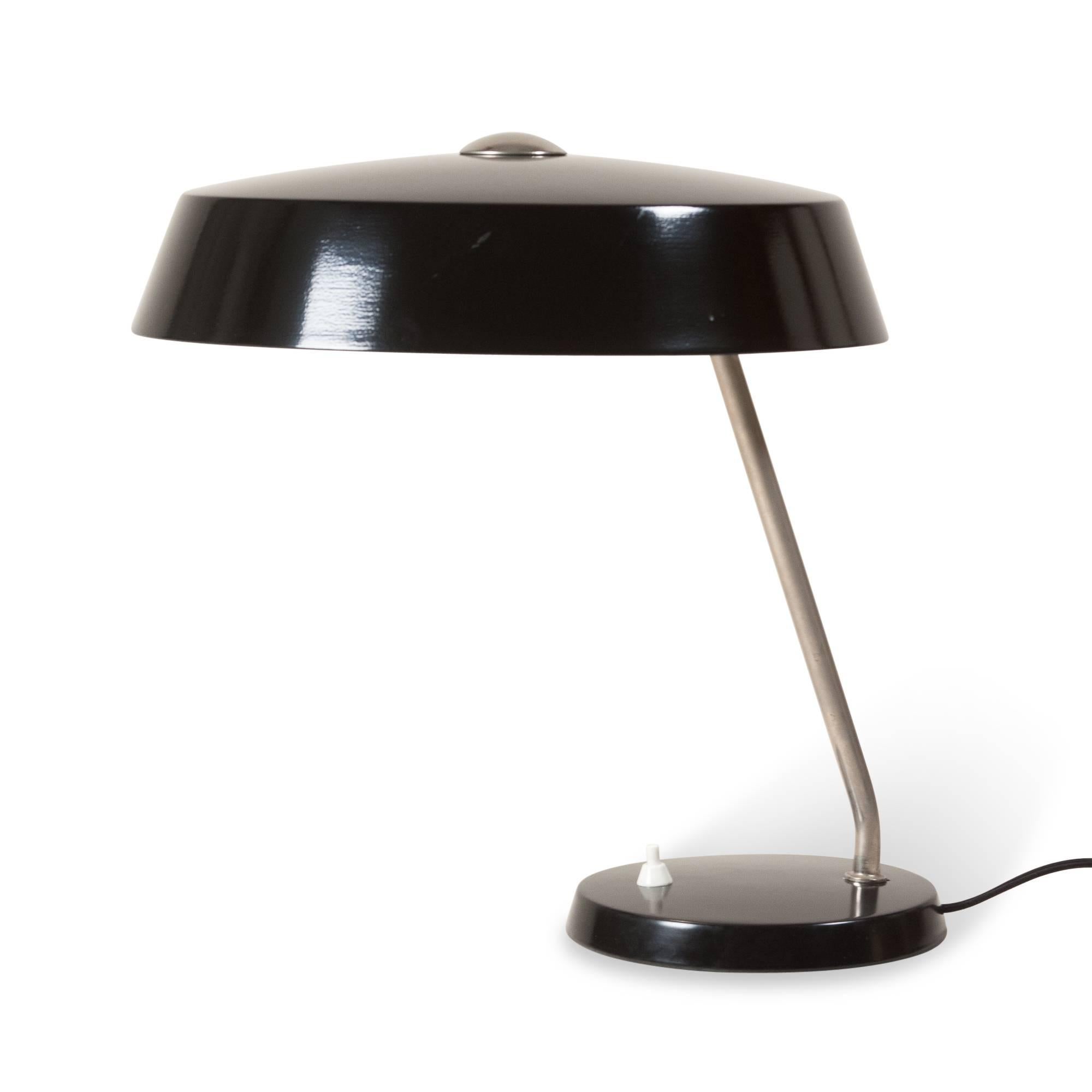 Black lacquered desk lamp, circular dome shade mounted on circular base, German, 1950s. Overall height 16 in, diameter of shade 12 in, diameter of base 7 in.