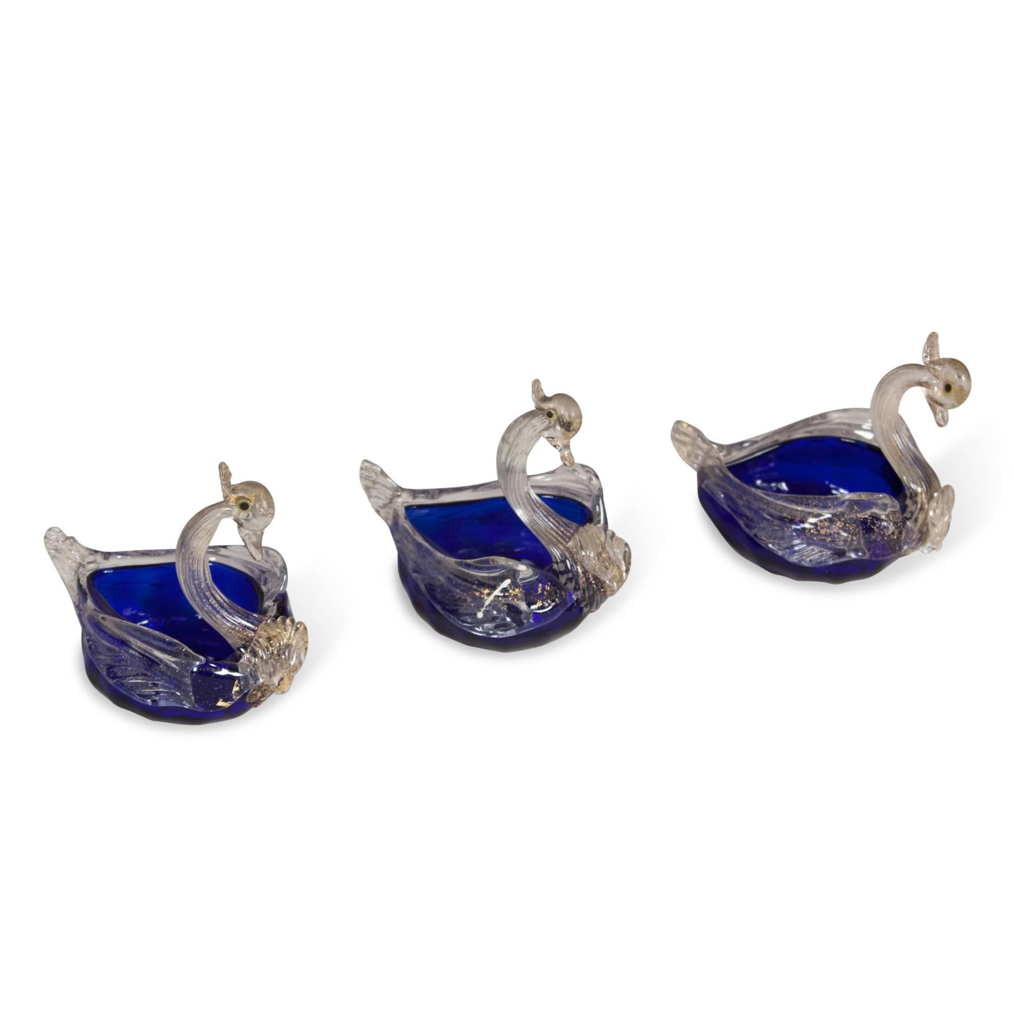 Set of three hand-blown glass swans, in clear and blue with gold inclusions, Murano, Italy 1960s. Height 3 in, length 4 in, width 2 1/2 in. (Item #2174 sats)