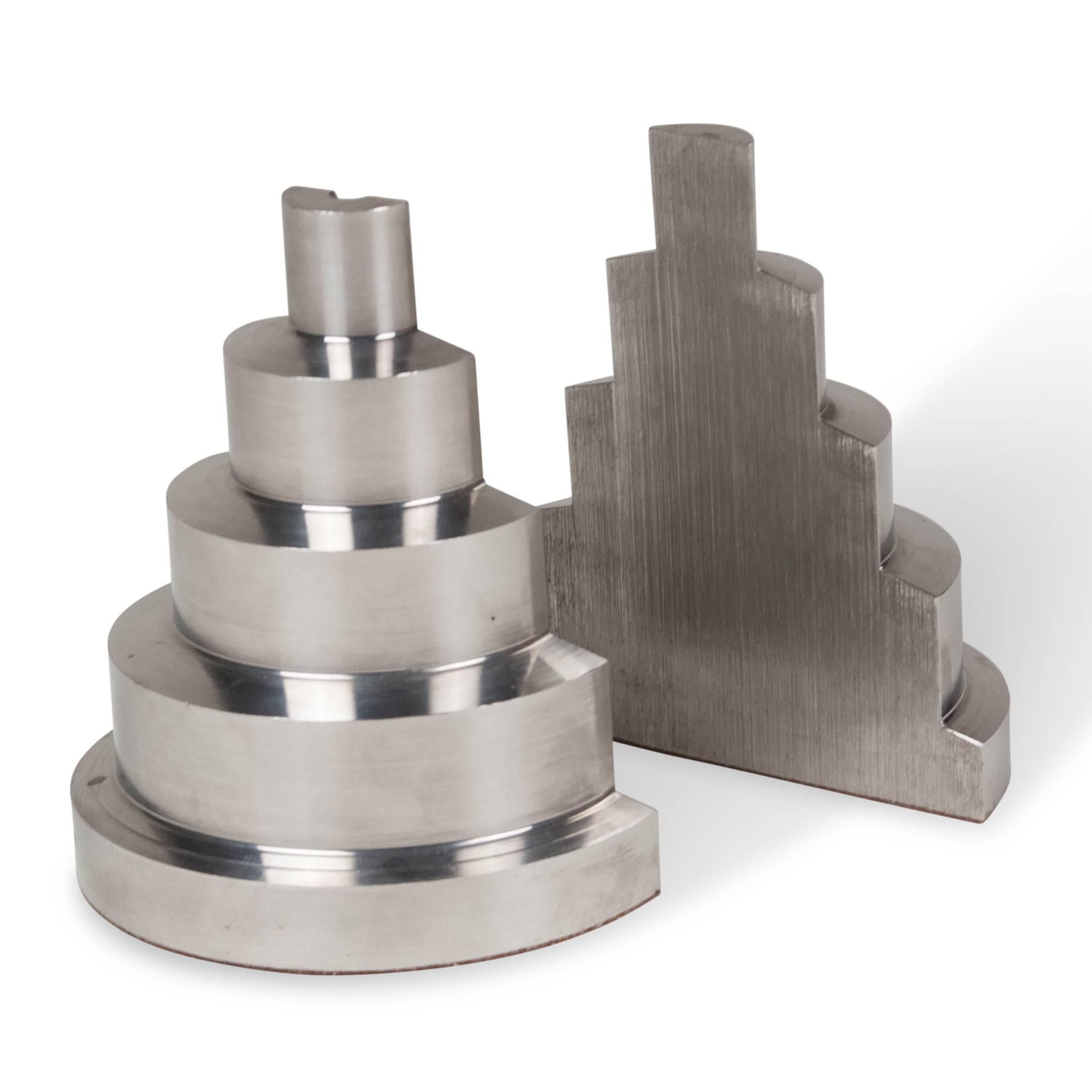 Pair of machined stainless steel bookends, of stepped semi-circular shape, American, 1930s. Measures: Each height 5 1/4 in, width 4 1/4 in, depth 1 7/8 in. (sats)

Price for the pair.