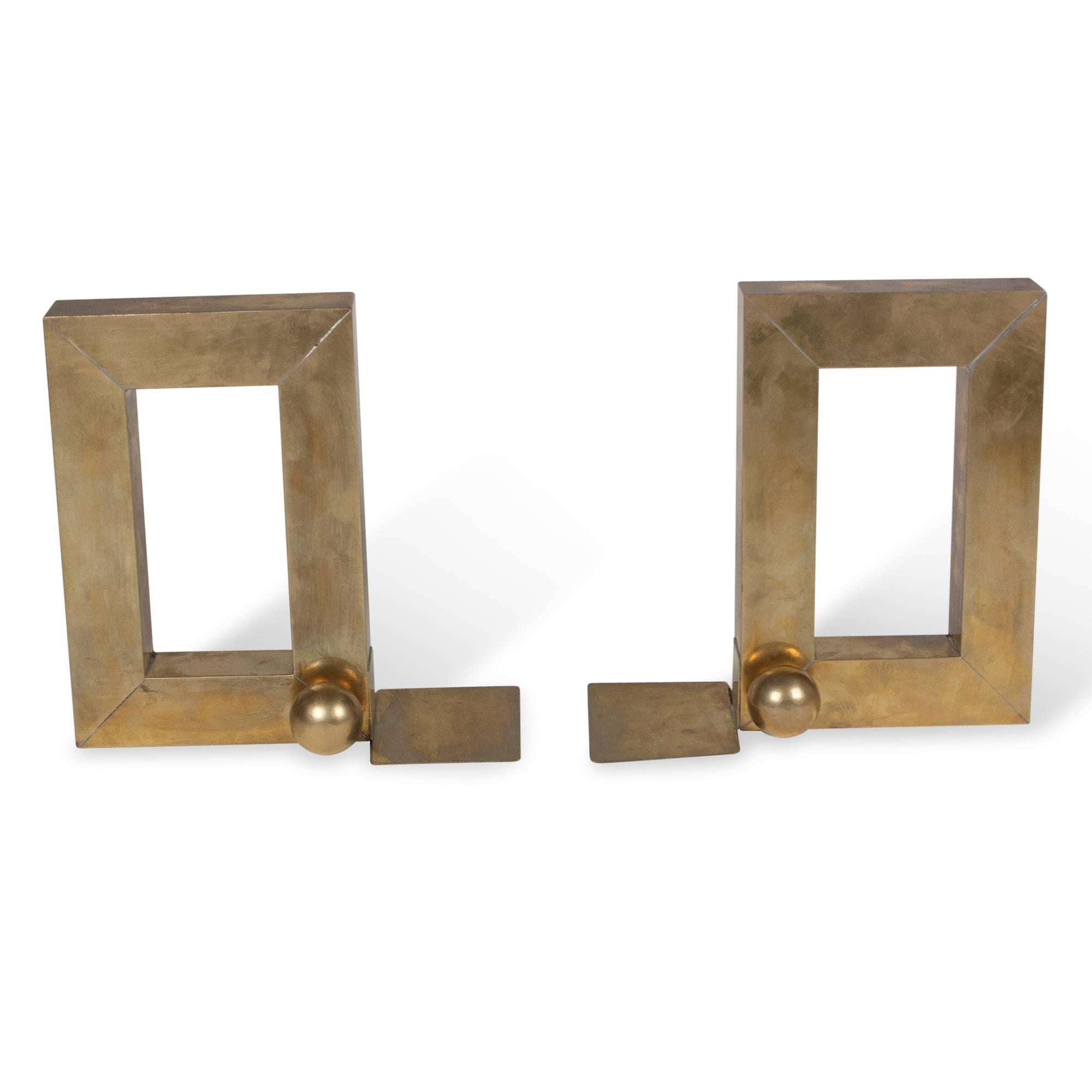 Pair of open rectangular shape brass bookends, with large ball accents at the base, United States, 1930s. Measures: 6 in x 9 in, width of body 1 1/2 in, overall width 4 in. 