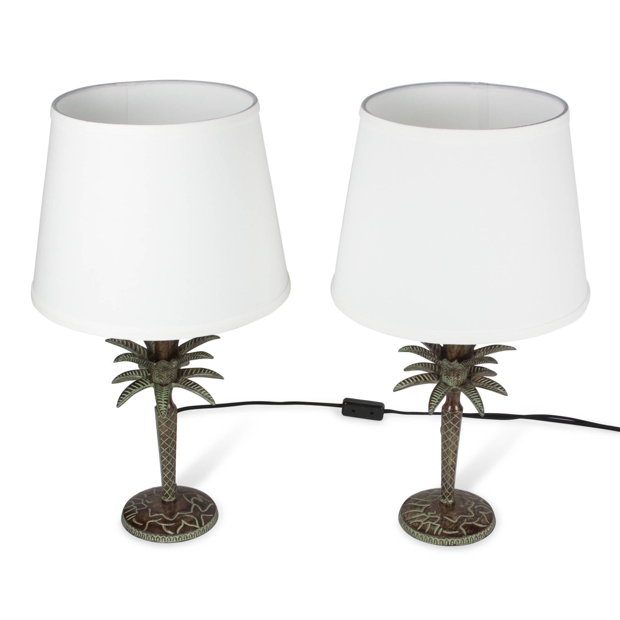 Pair of patinated bronze table lamps, plant form with leaves and having engraved decoration, France, 1990s. Overall height 22 in, diameter of base 5 1/4 in. Shade measures top diameter 9 in, bottom diameter 12 in, height 10 in.

Price for the pair.