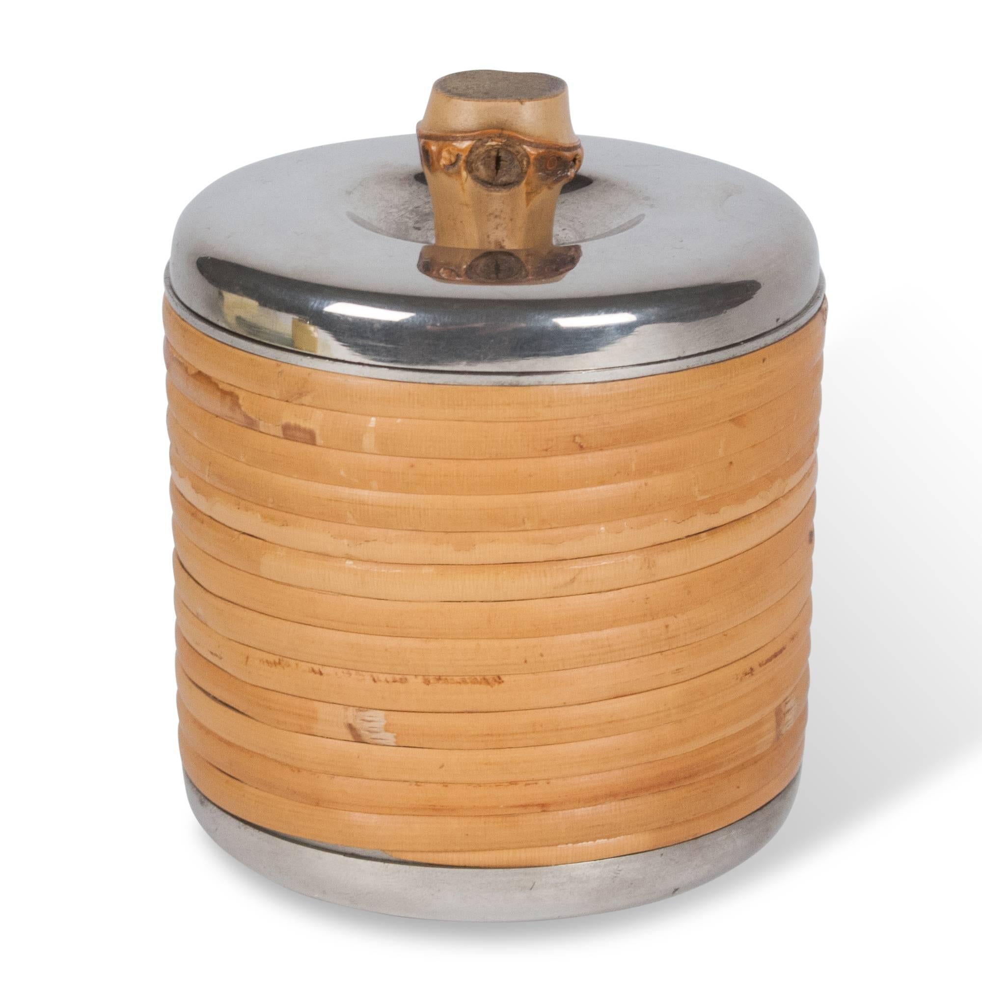 Stainless steel cylindrical lidded box, rattan wrapped with bamboo handle by Carl Auböck, Austria, 1950s. Measures: Height 3 3/4 in, diameter 3 3/8 in.