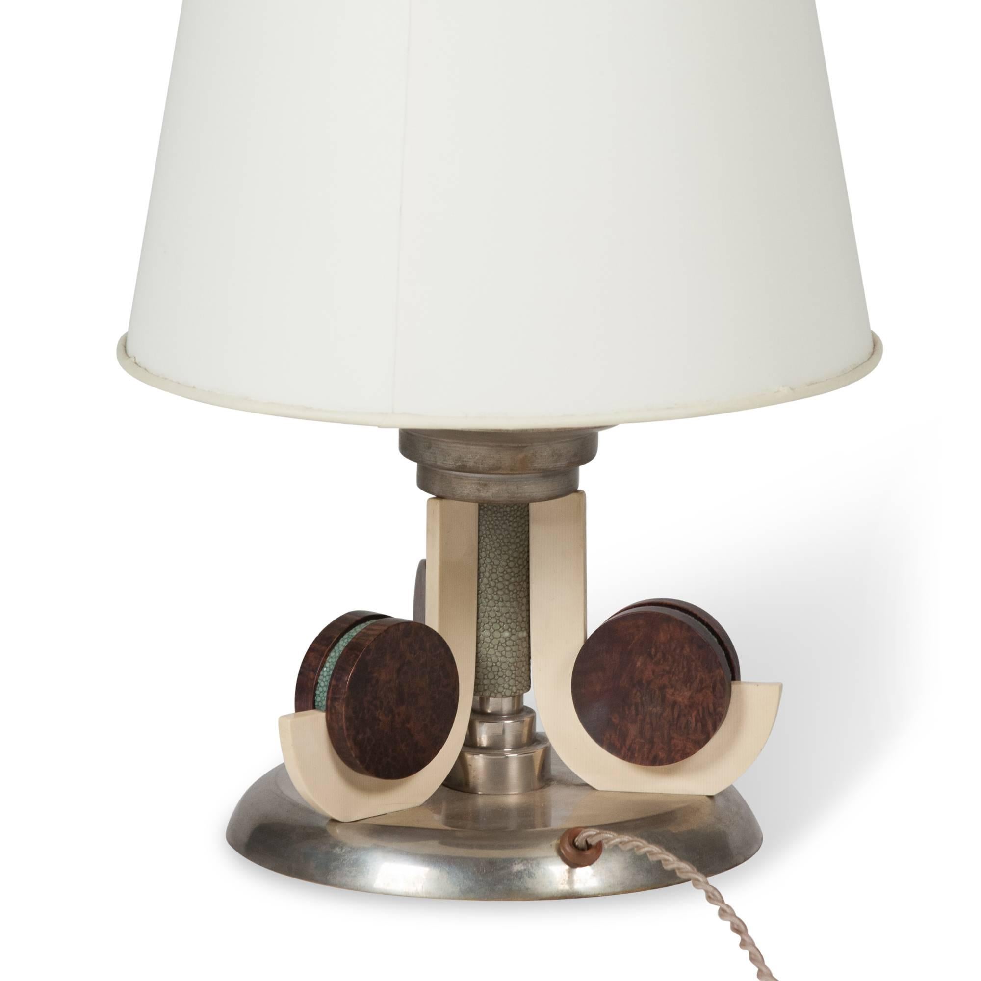 Galuchat (shagreen), nickel and Macassar table lamp, central column with three flanged elements, on a circular nickel base, R & Y Augousti, French, 1980s. Measures: Overall height 15 1/2 in, diameter of base 8 in, bottom diameter of shade 11 in.