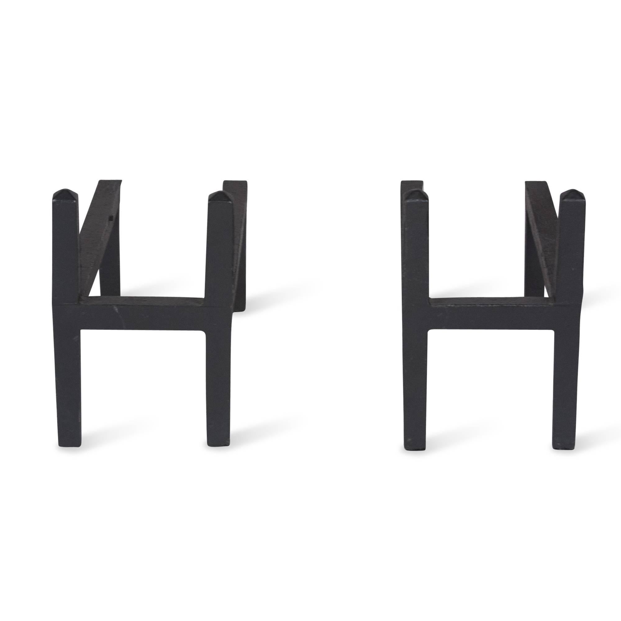Pair of simple H-form iron andirons, with double backs, American, 1960s. Measures: 6 5/8 in. H, 4 1/2 in. W, 12 in. D.