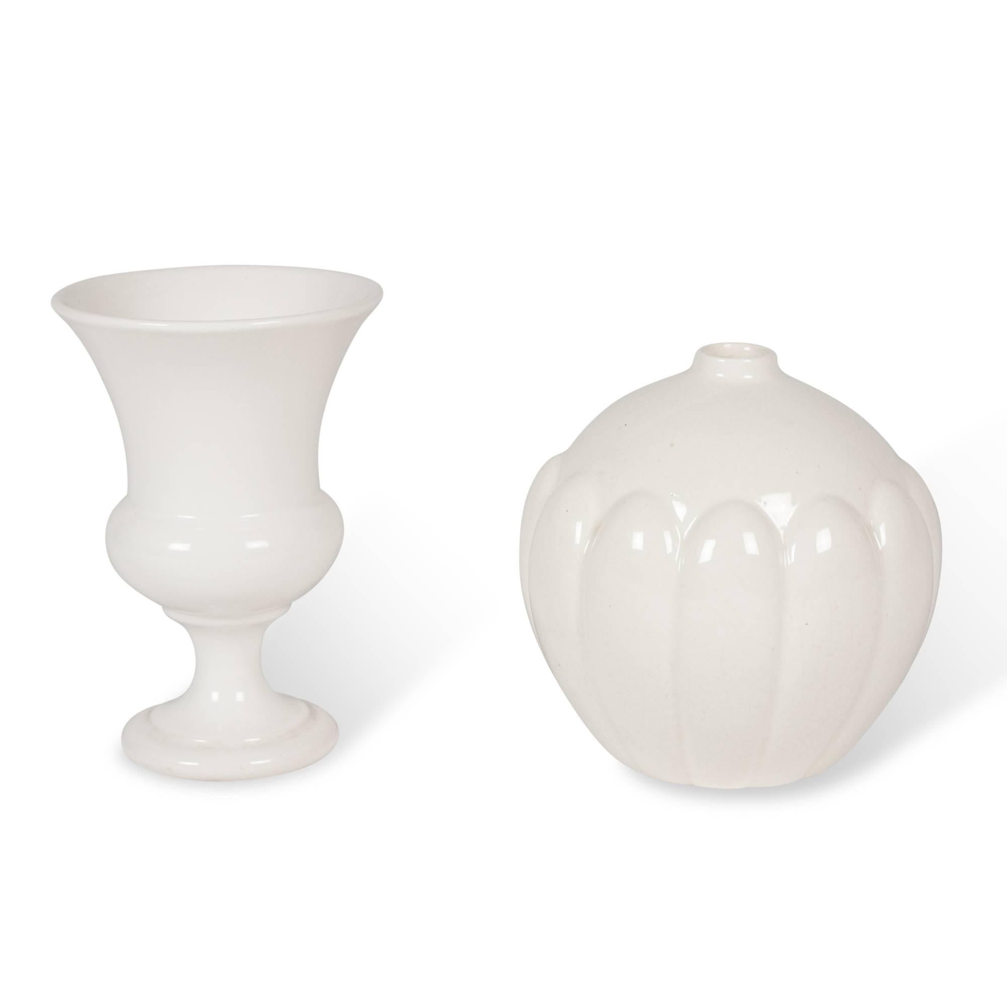 Set of two vases:
On left: White ceramic urn form vase, tapered open body on foot, by Pol Chambost, France, circa 1950. Signed to underside. Measures: Height 7 3/4 in, diameter of opening 5 in, diameter of base 3 1/2 in.
On right: Off-white