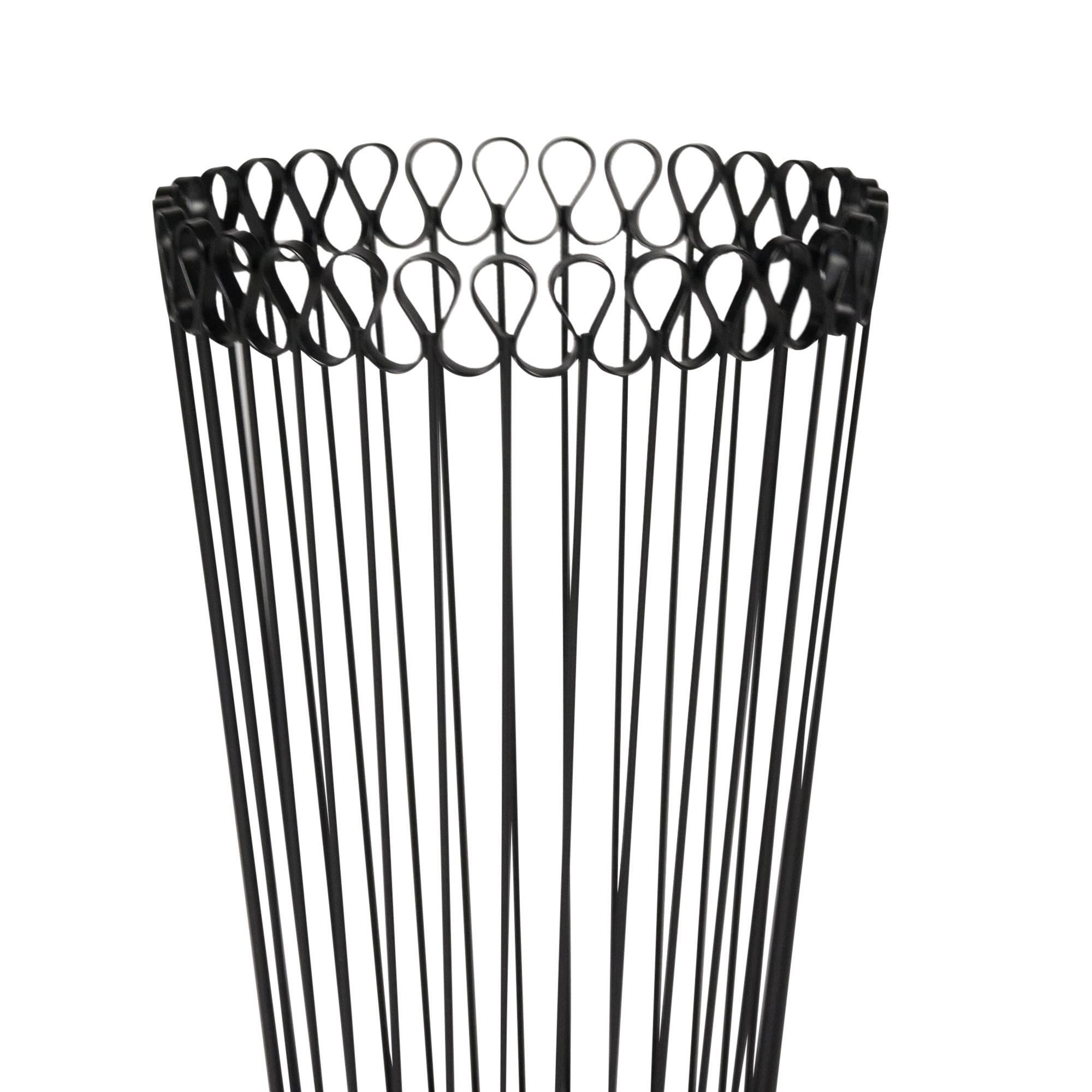 Circular iron waste basket, with scalloped rim, the sides formed by thin iron rods, Austria, 1950s. Measures: Height 16 in, top diameter 9 1/2 in, bottom diameter 8 in.
 