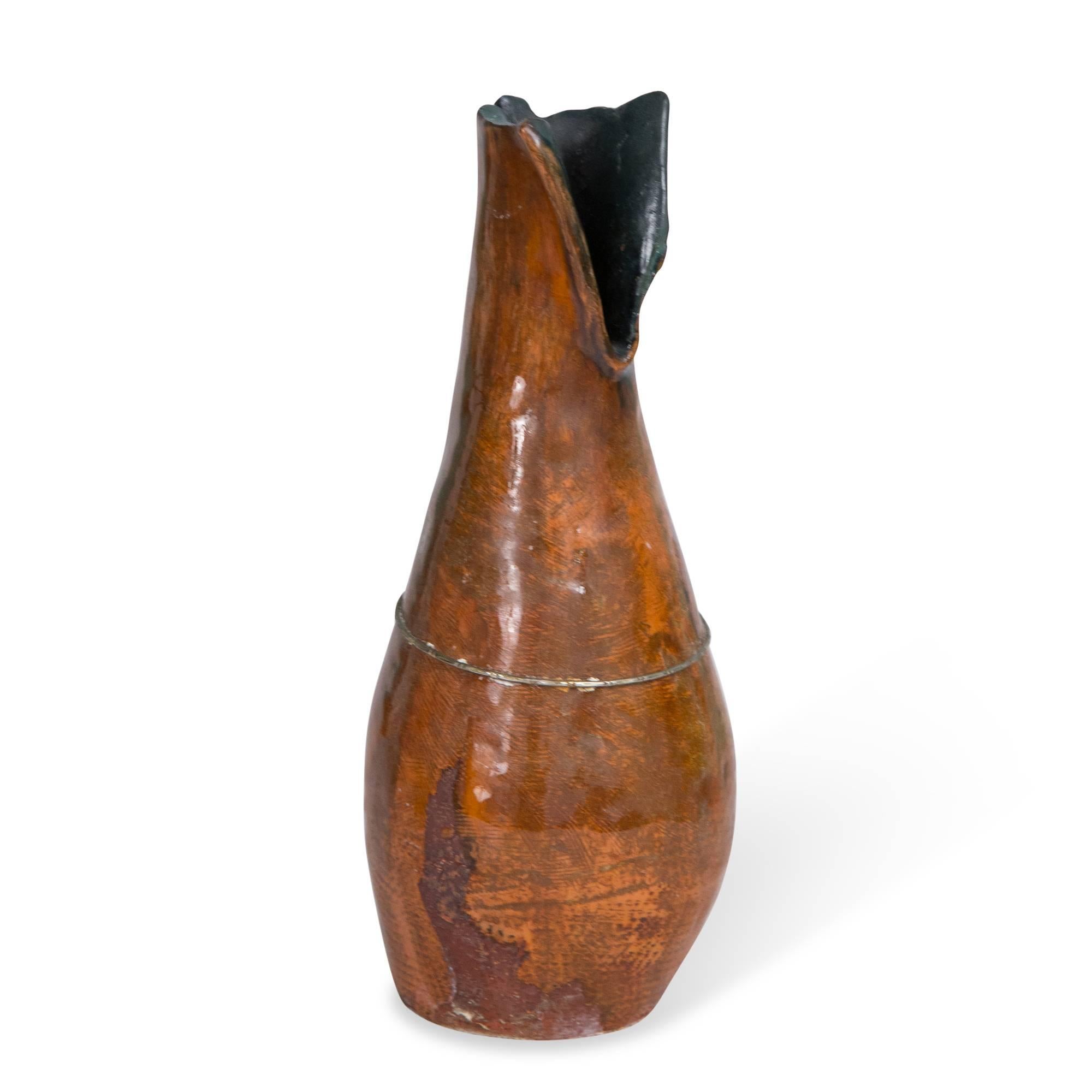 Red glazed hand built ceramic vase, with rough opening at top, and applied metal wire around body, by Juliette Derel, France, late 20th century. Measures: Height 8 in, diameter 3 in.