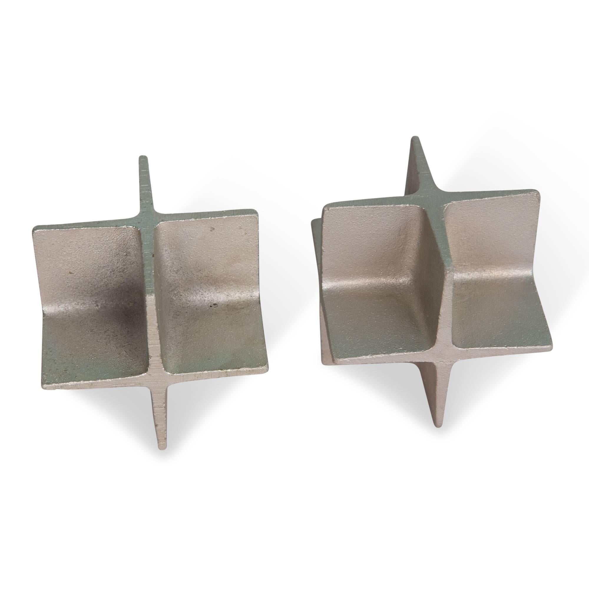 Pair of cast steel cubic bookends or desk paperweights, with protruding cross shapes on every side, by Carl Auböck, Austria, early 1960s. Cubic dimensions 4 in. (sats)