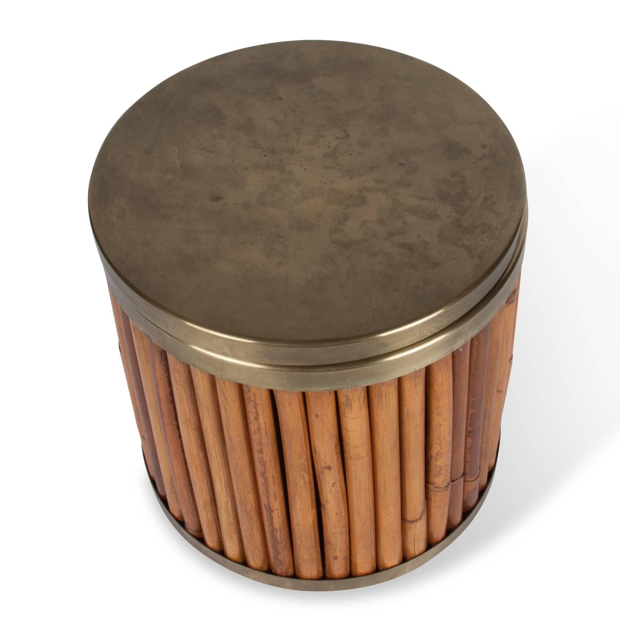 Bamboo and brass wastebasket, vertical bamboo rods resting in brass cap and base, with brass lid, by Gabriella Crespi, Italy 1970s. Measures: Height 8 1/2 in, diameter 8 1/4 in. (sats)

Note: Some signs of gentle use and normal aging to brass.