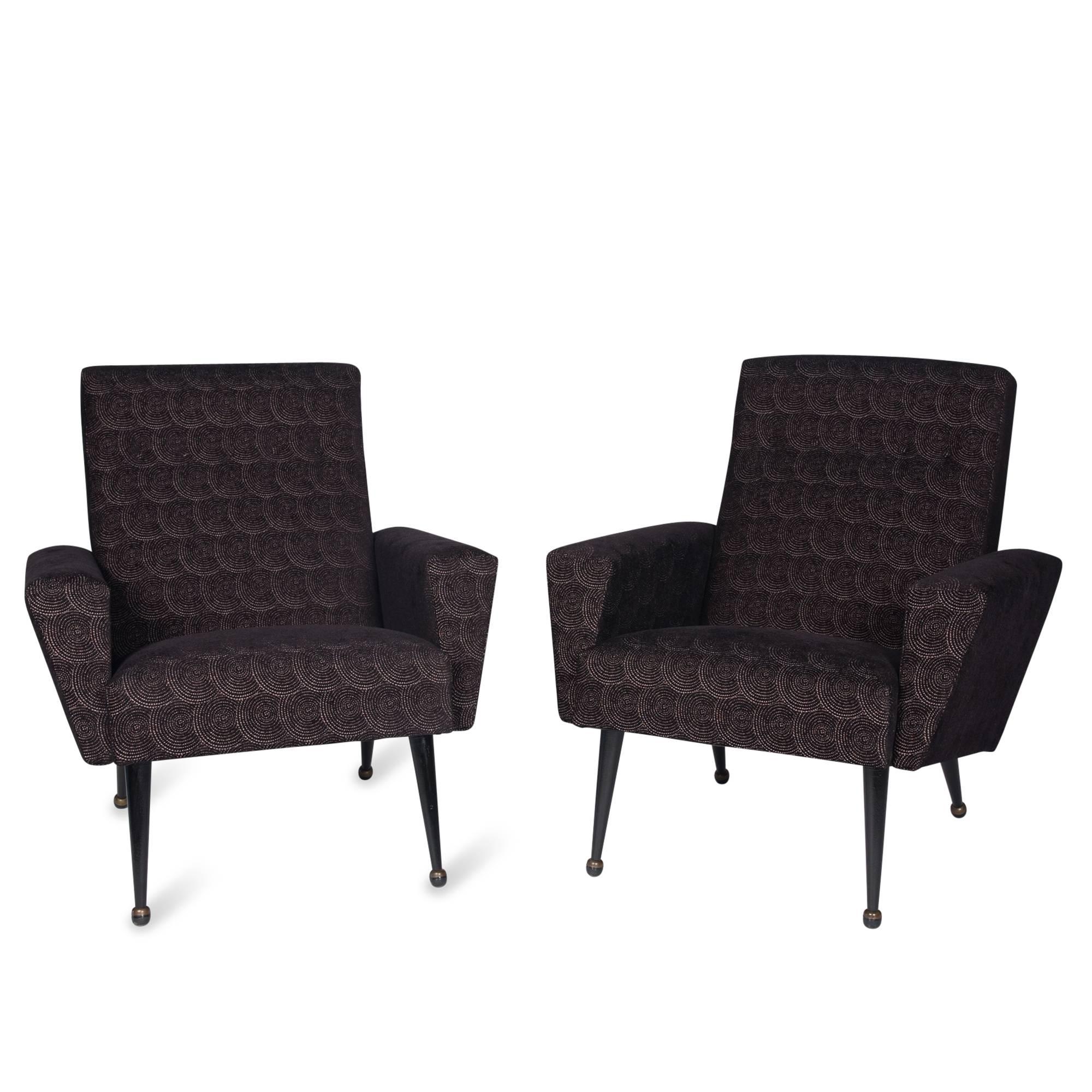 Pair of upholstered armchairs, angled arm sides, with painted iron legs and bronze ball sabots by Airborne, France, 1960s. Measures: Width 28 in, depth 30 in, back height 32 in. seat height 18 in.