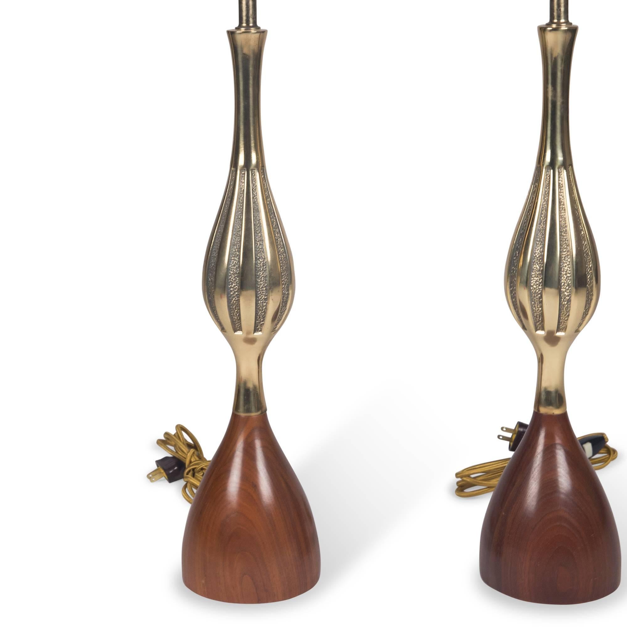Fluted bronze tapered form table lamps, on cone-shaped walnut base, United States, early 1960s. Measures: Height to top of socket 24 in, diameter at base 5 in. Height of wood portion 6 1/2 in.