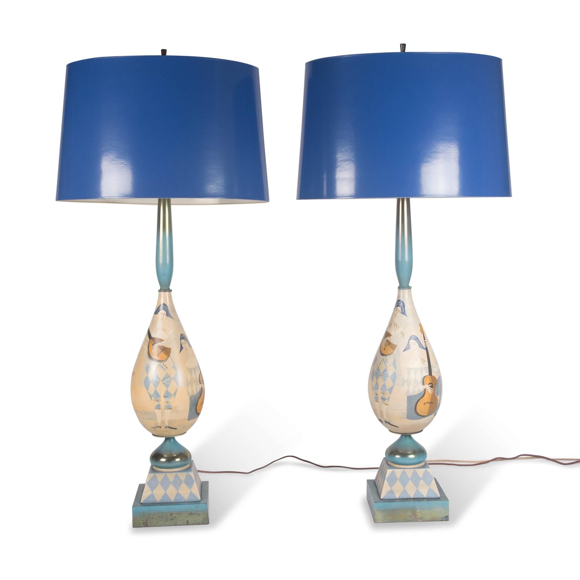 Pair of tall painted wood table lamps, ovoid central element mounted on a square base, with tall narrow neck, Italy, 1930s. Painted with scenes of musicians. In custom blue paper shades. Measures: Overall height to top of shade 43 in. Base measures