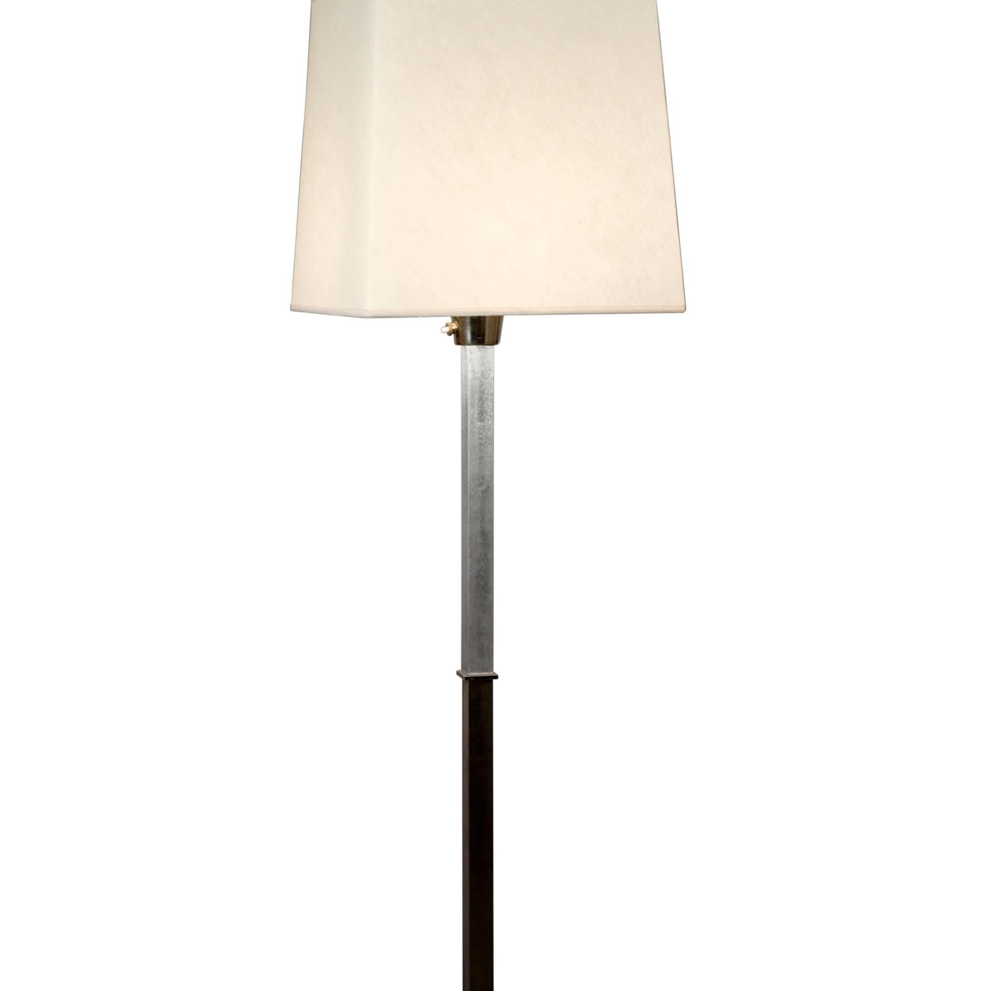 Cruciform base polished steel floor lamp, having a square column and base, the top section polished solid aluminium, in custom square shade, French, circa 1970. Overall height to top of shade 72 in. Shade measures top 12 in square, bottom 14 in